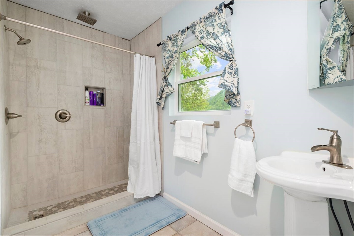Bathroom one is accessed through bedroom one and has a walk in shower