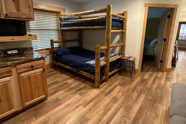 Lower level of the cabin with bunk bed & sofa
This area also has a sink, fridge, & cabinet space.