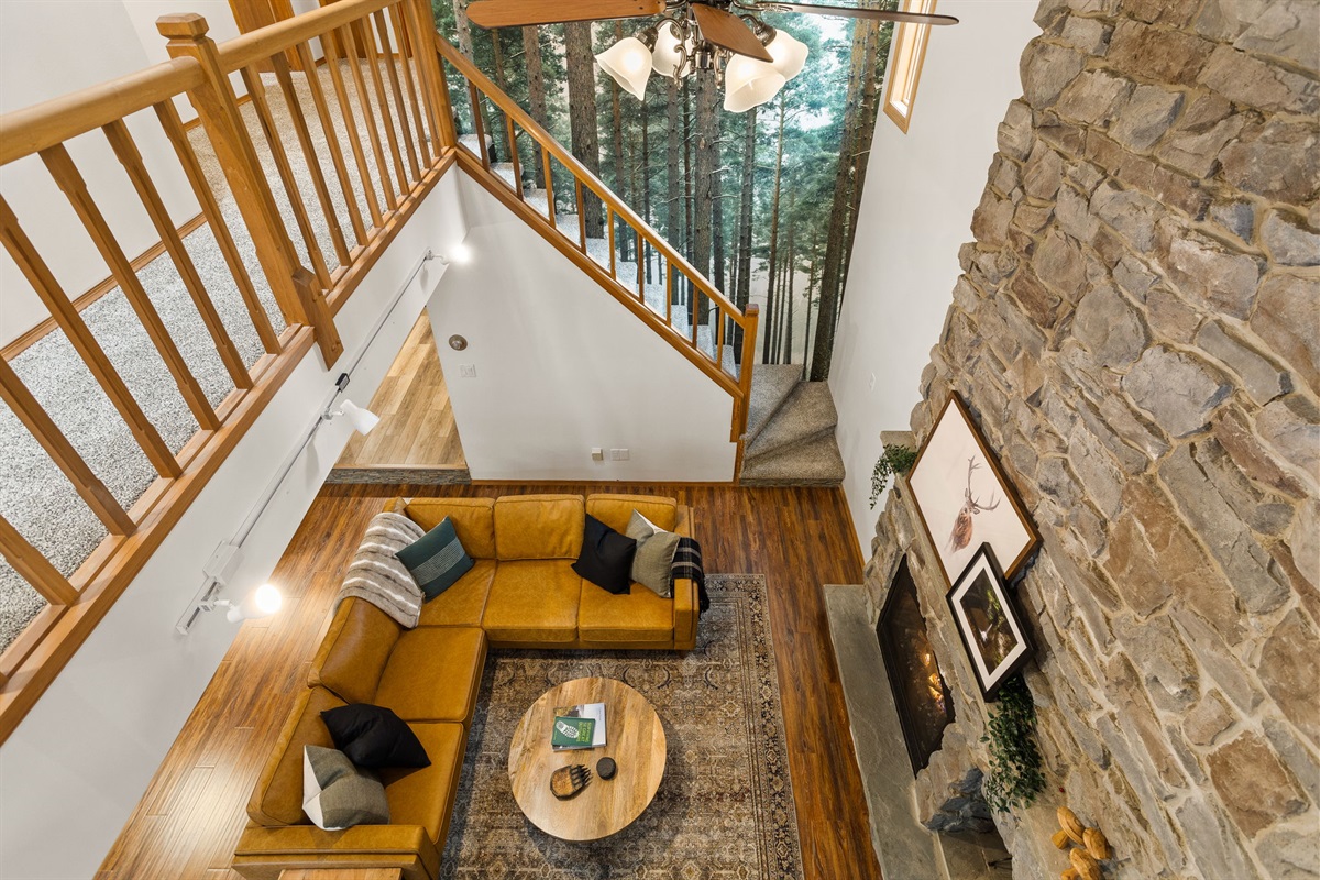 From above, the living room truly comes to life! Open, inviting and thoughtfully designed for connection. Whether it’s cozy nights by the fire or laughter-filled gatherings, this is the heart of the home where your best moments unfold