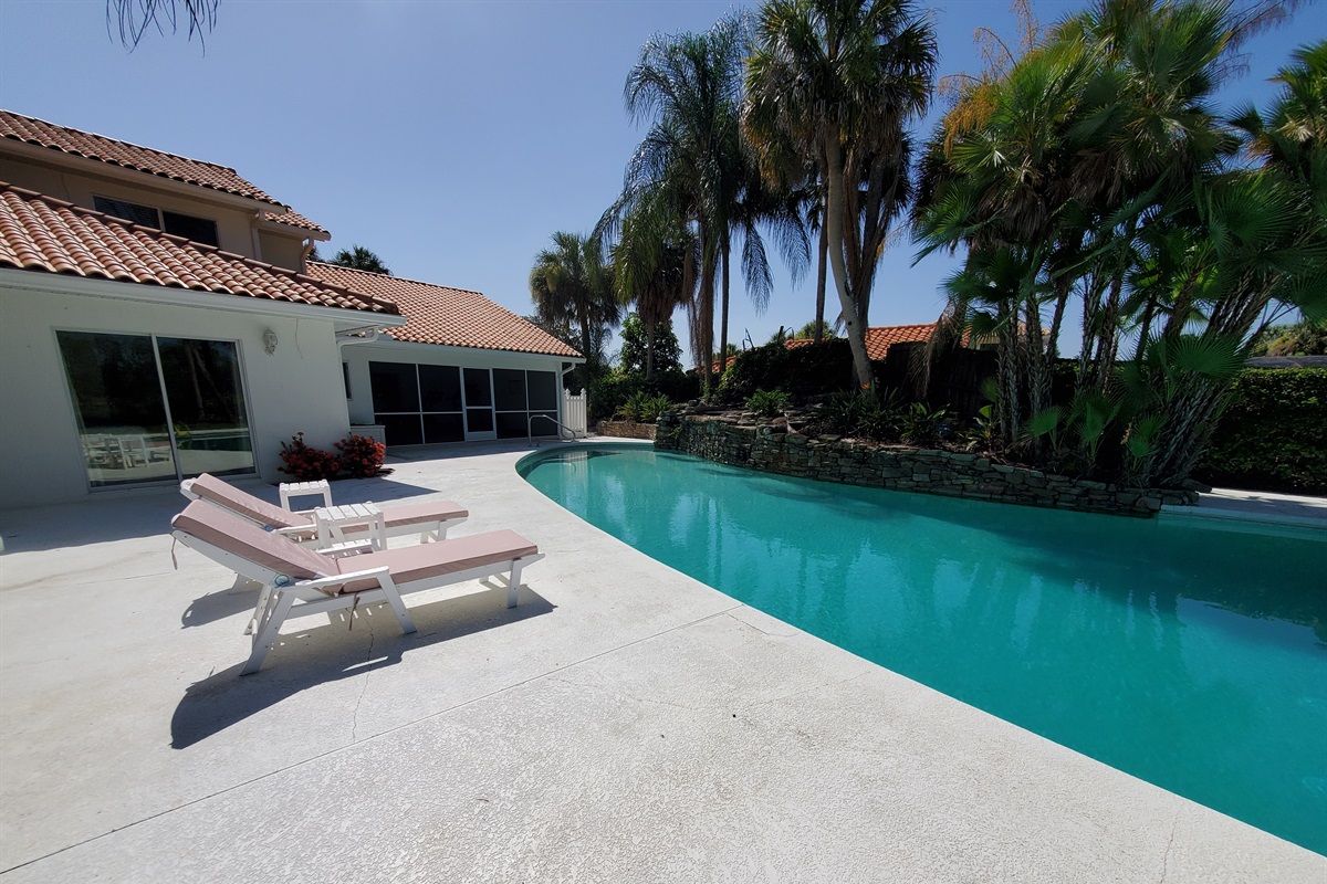Pool view, loungers and fitness area/gym with ping pong table screened in room on right