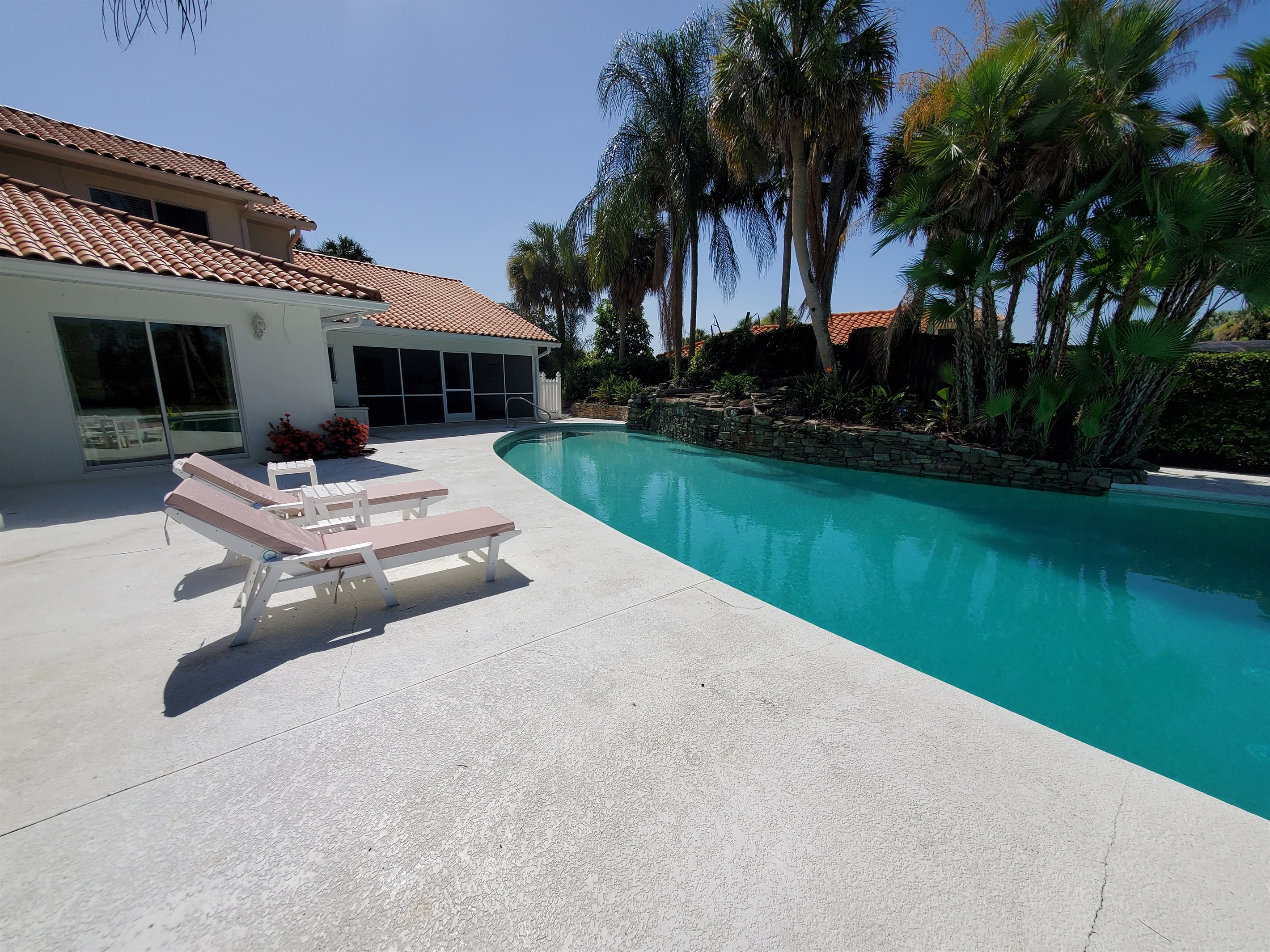 Pool view, loungers and fitness area/gym with ping pong table screened in room on right