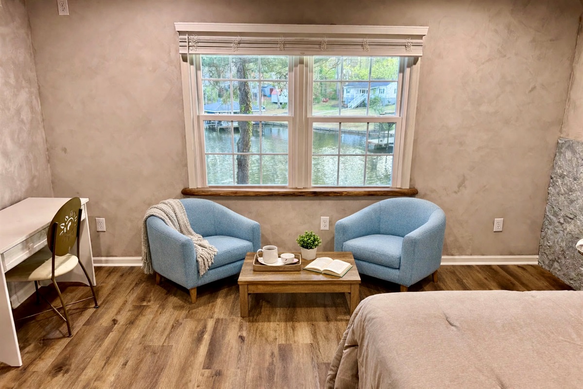 Master bedroom, sitting area overlooking the water and desk.