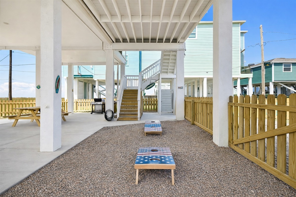Cornhole Area (Ground Level): Friendly backyard competition in your private fenced yard.