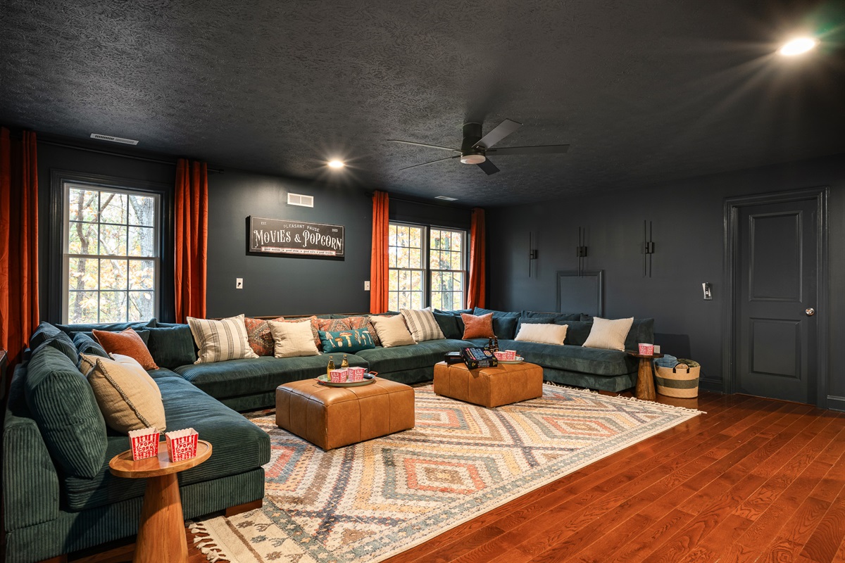 Movie nights hit different here — a giant cozy sectional, dim lighting, and space for the whole crew