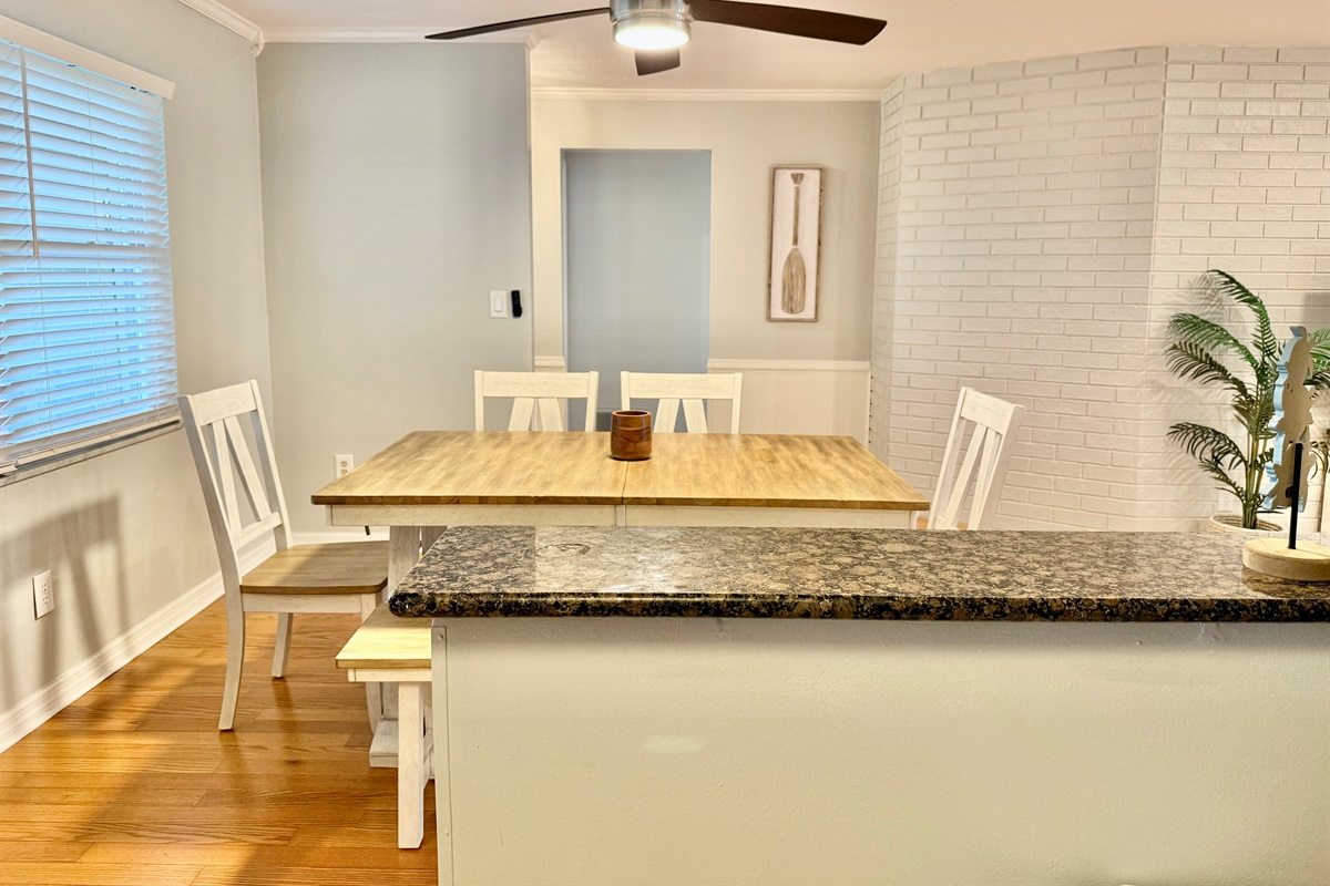 Gather, dine, and connect in this coastal-chic dining space with seating for six and easy flow to the kitchen.