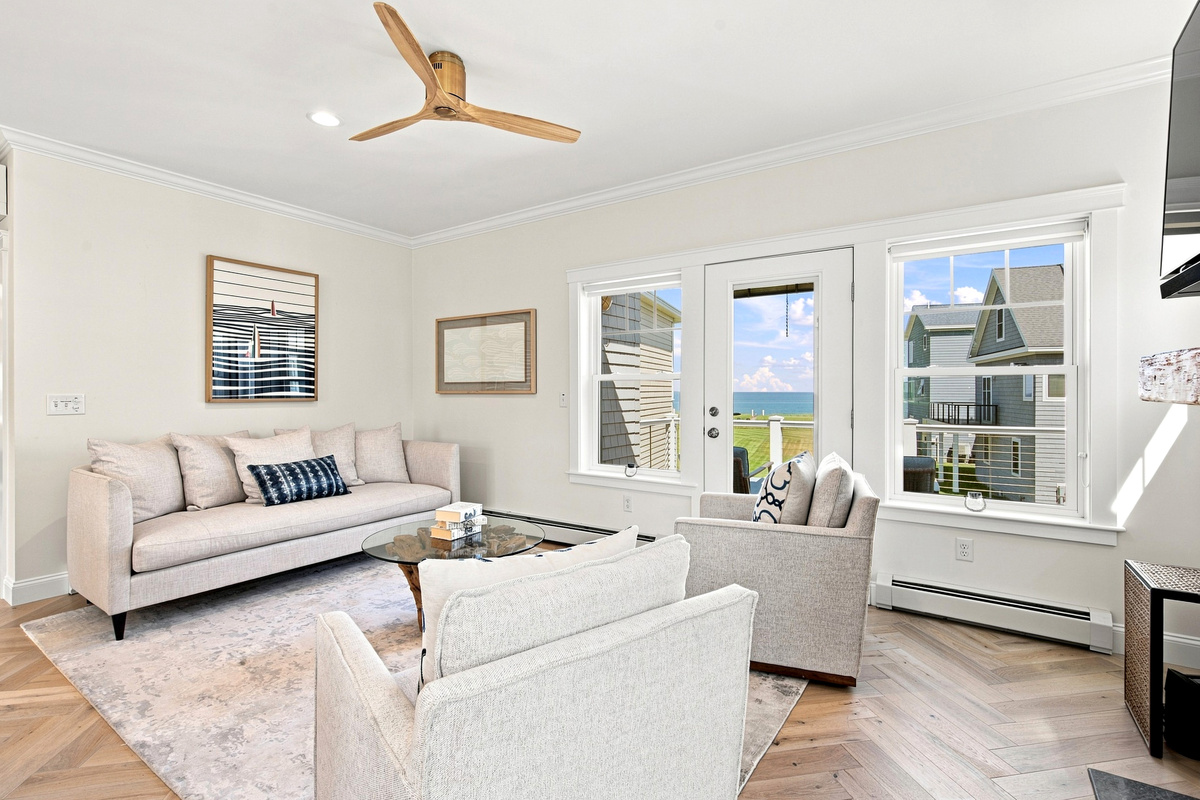 Kick back and relax in this comfortable sitting area filled with natural light and coastal charm.
