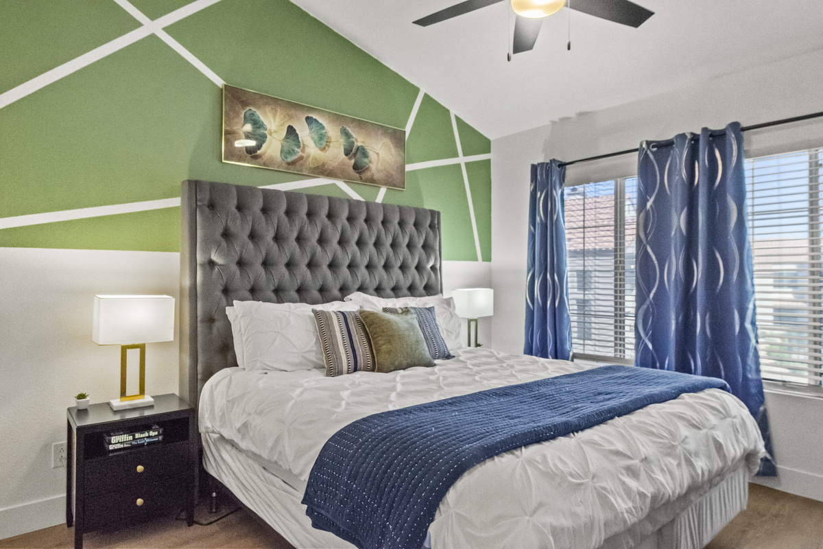 Relaxing bedroom with two bedside tables, a huge window for natural light, and a hybrid mattress for added comfort. 