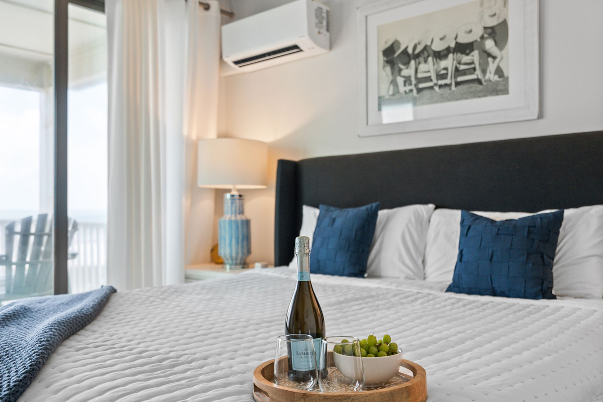 Your private sanctuary featuring an ensuite bathroom and direct access to a deck overlooking the sparkling gulf.