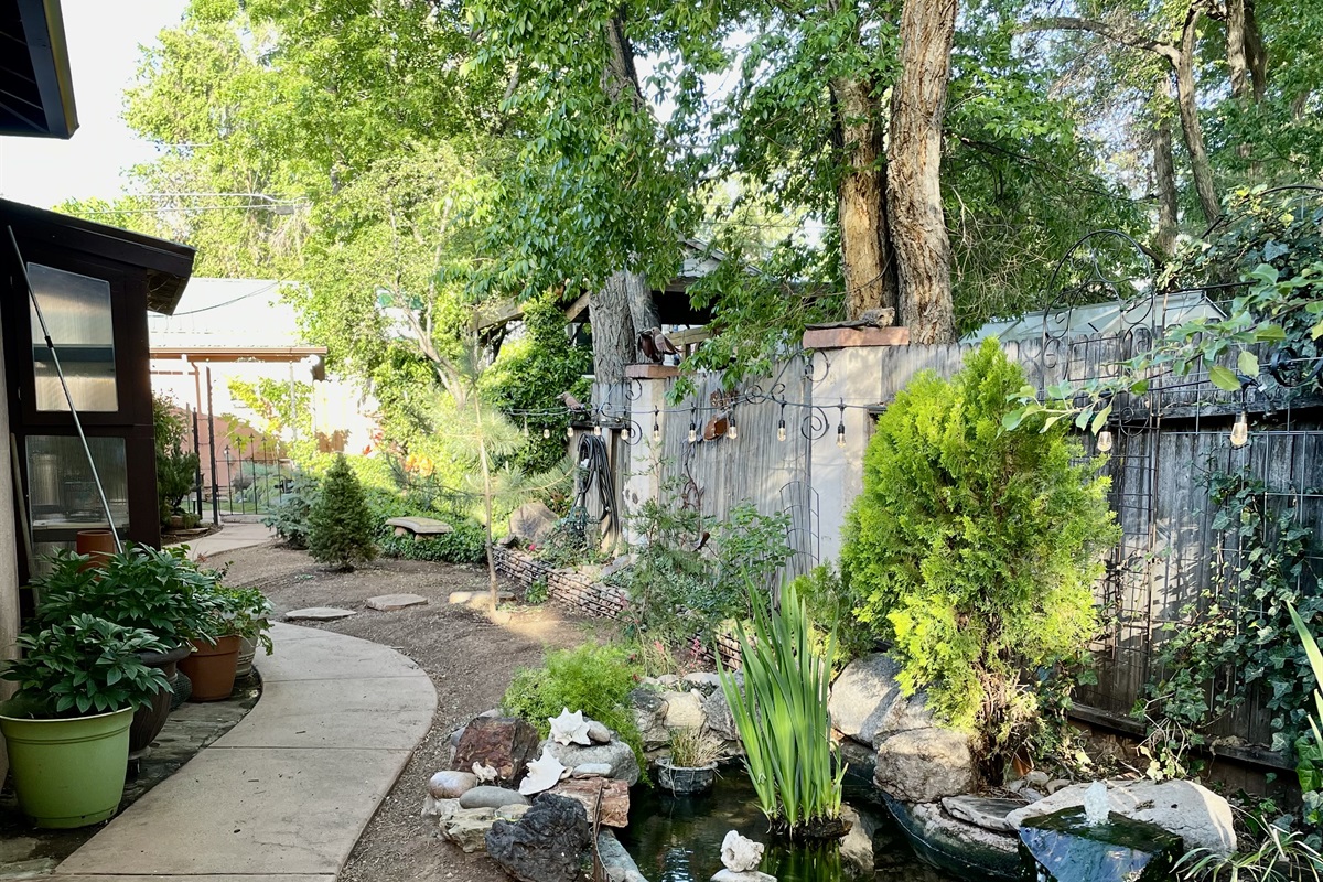 Tranquil garden with colorful koi swimming in a peaceful pond.