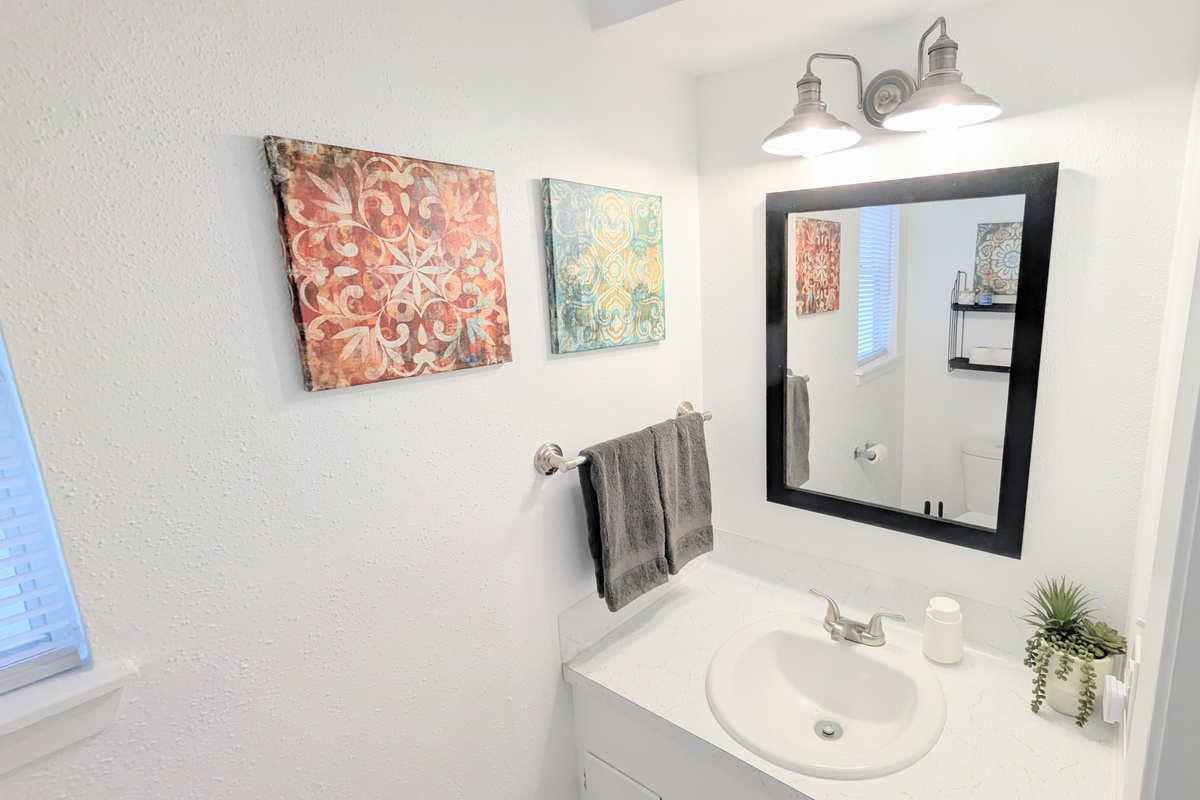 Stocked with a hair dryer, step stool and toiletries, the downstairs half bath can also serve as an additional place to get ready. 