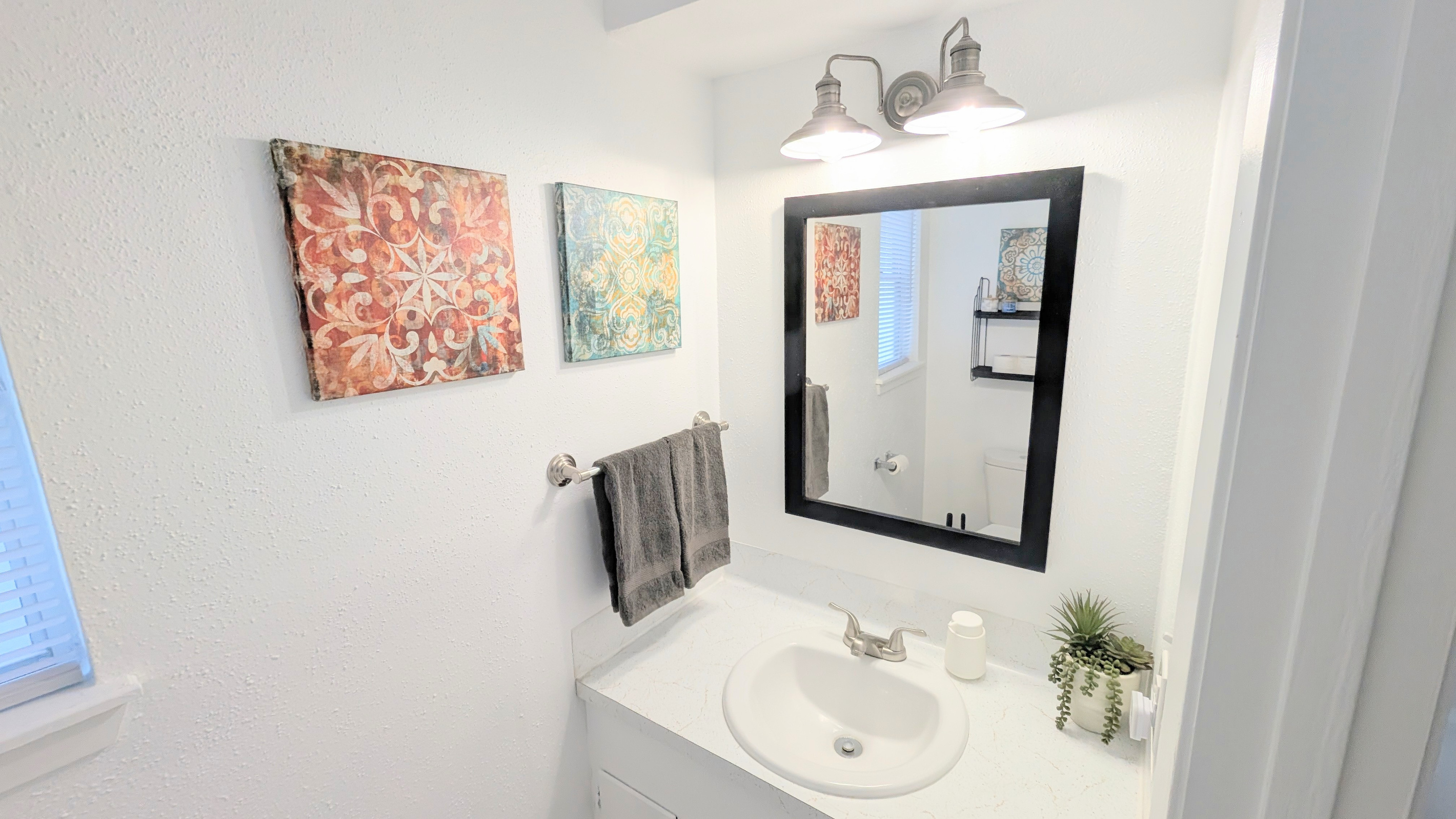 Stocked with a hair dryer, step stool and toiletries, the downstairs half bath can also serve as an additional place to get ready. 