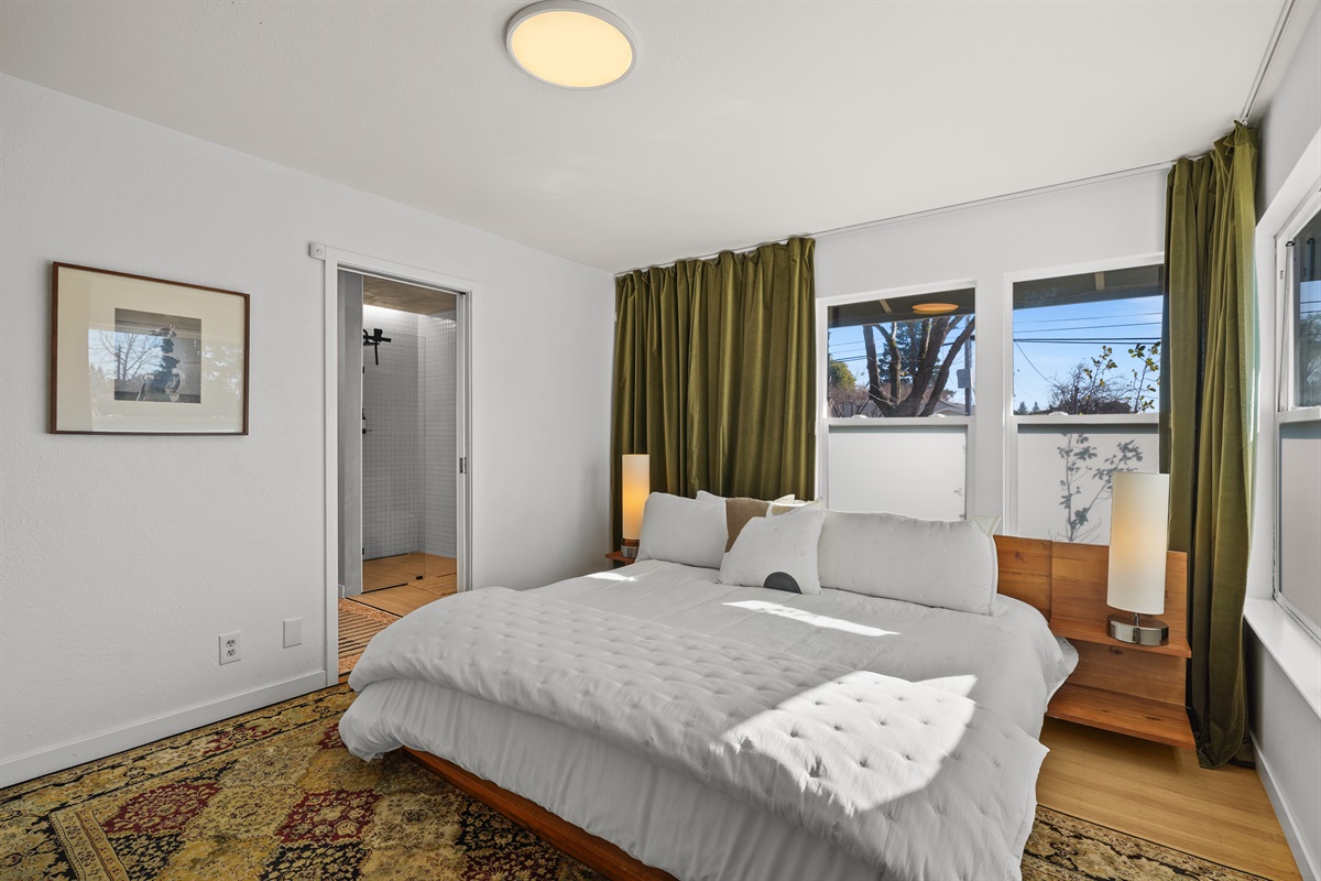 Spacious primary bedroom featuring a comfortable king bed, Smart TV, and plenty of room to relax after a day exploring Napa Valley.