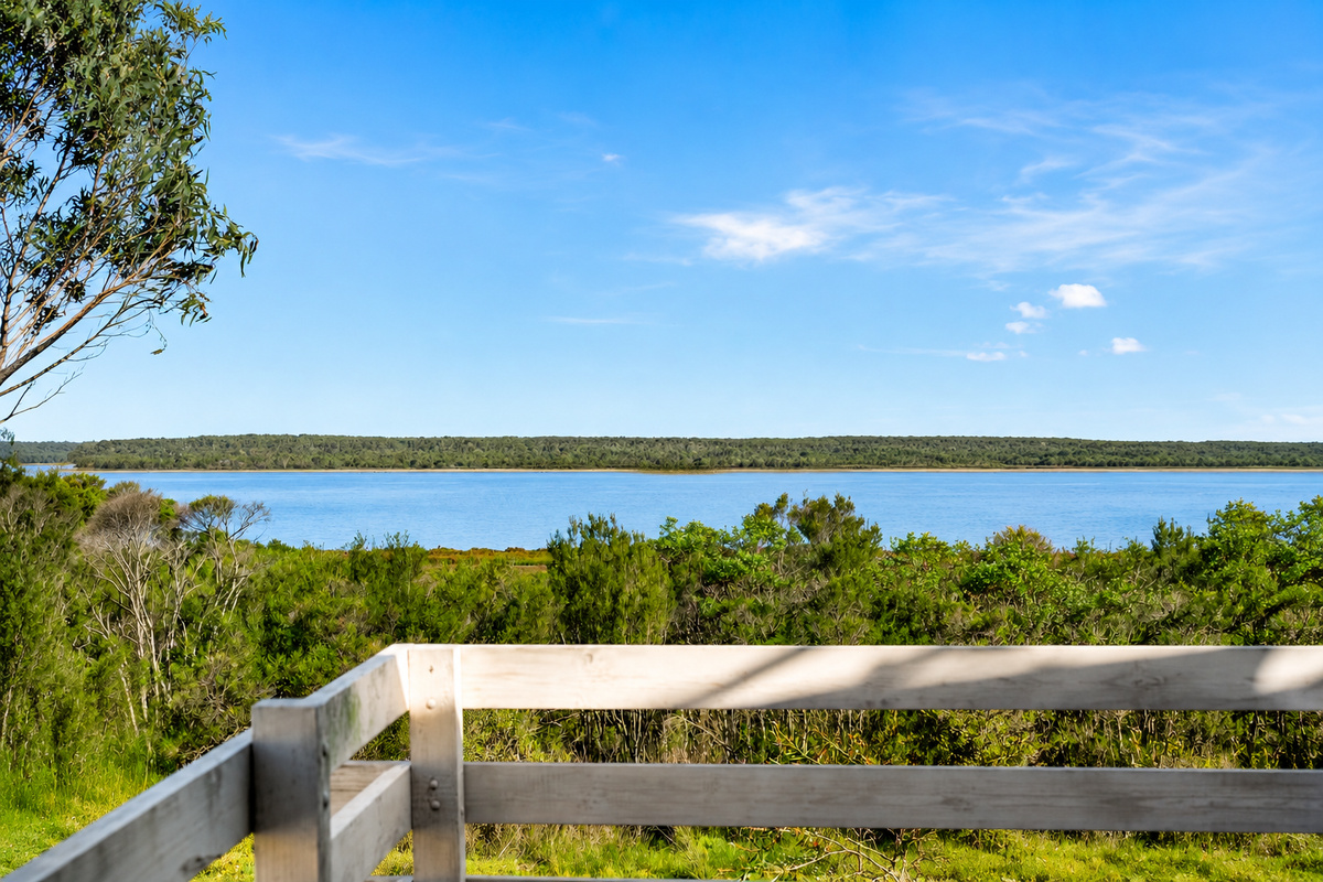 Take in the Lake Victoria outlook from the balcony at Carlenes Getaway, with treetops and open water shaping the Loch Sport setting