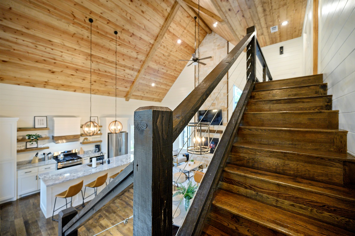 The staircase to the upstairs bunk room feels like the start of the fun part. 
Cozy cabin views, warm wood details, and a loft space waiting for game nights, laughter, and unforgettable sleepover memories.