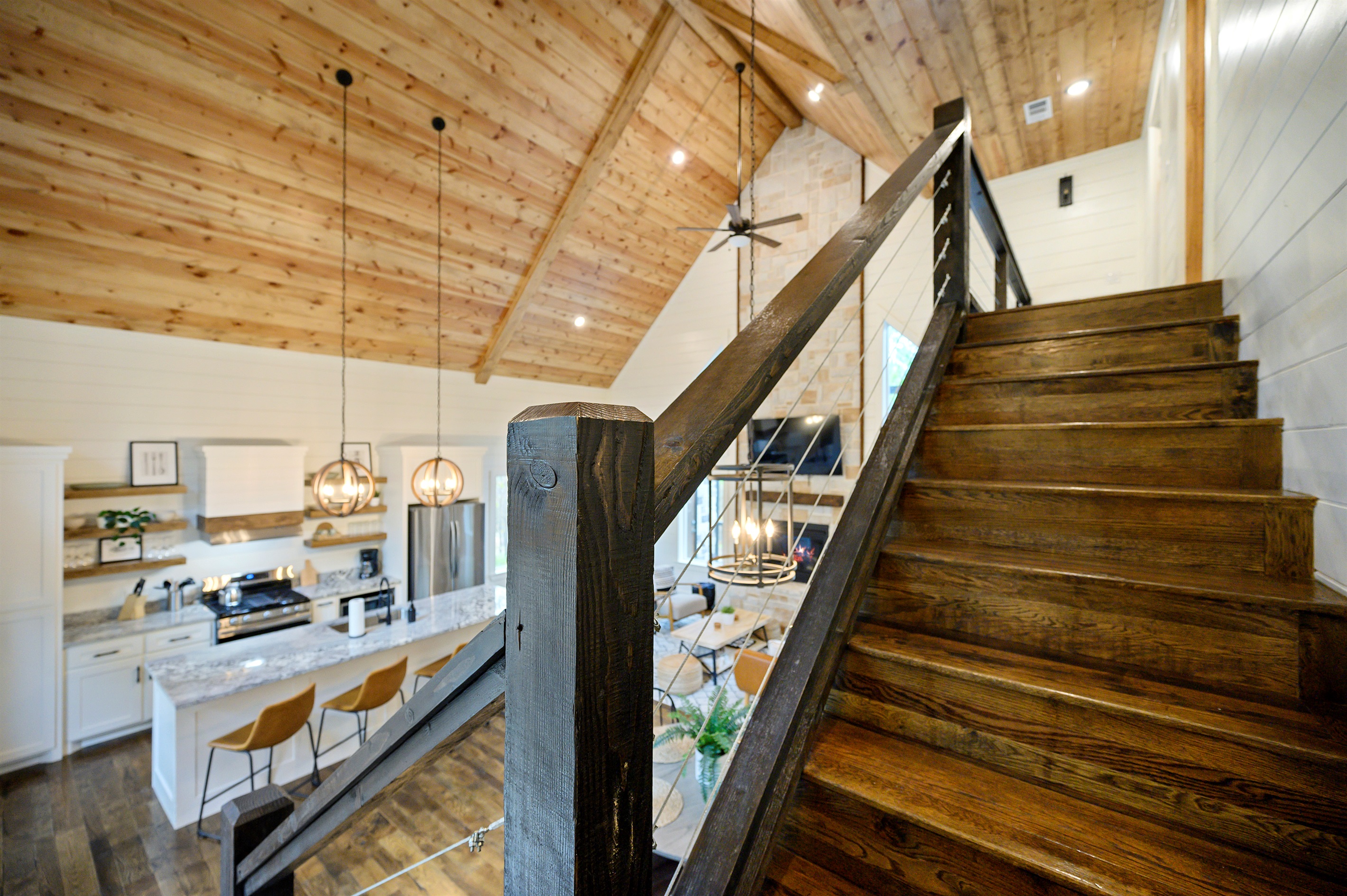 The staircase to the upstairs bunk room feels like the start of the fun part. 
Cozy cabin views, warm wood details, and a loft space waiting for game nights, laughter, and unforgettable sleepover memories.