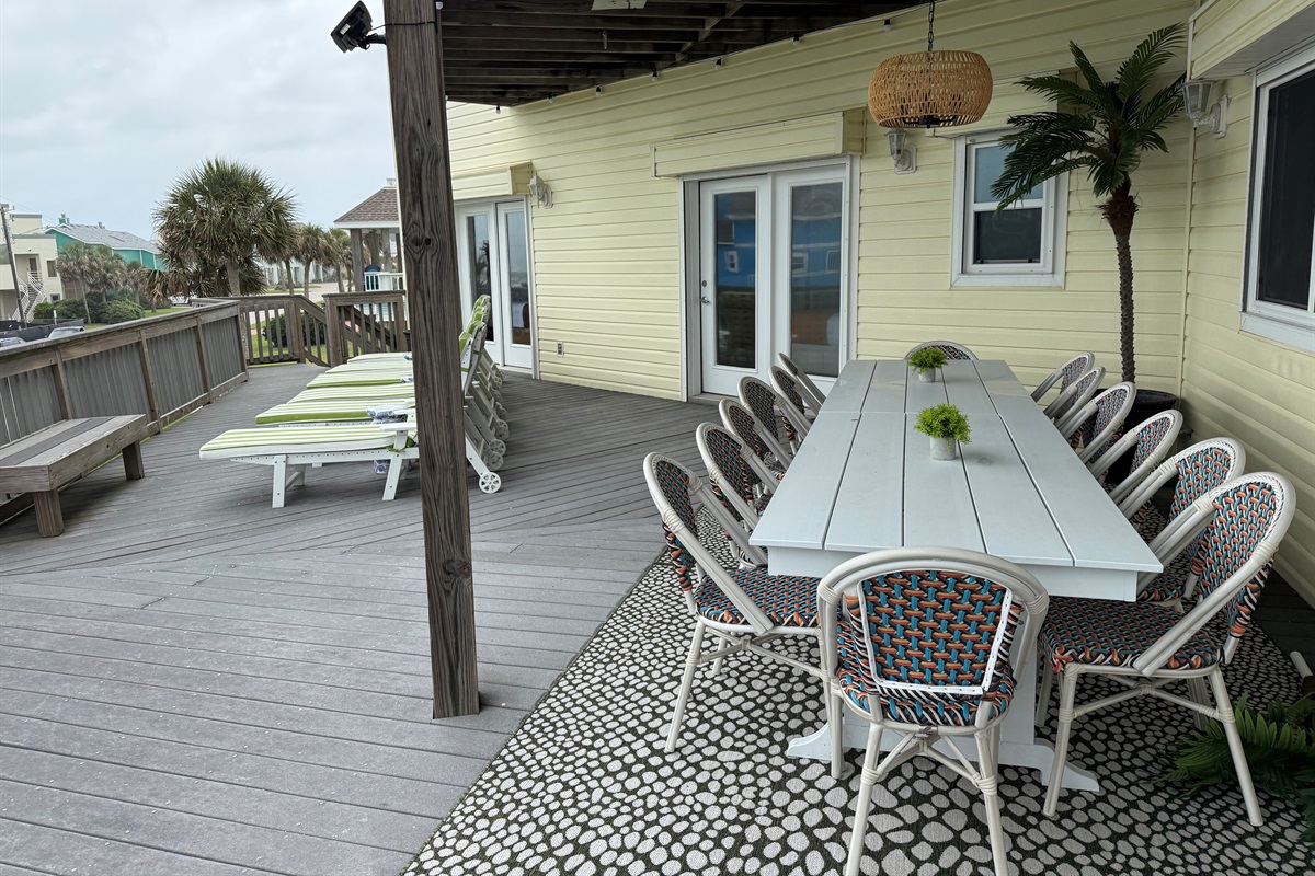 Main-Level Deck Outdoor Living
Dine alfresco with seating for 14 on the main-level deck, plus a cozy conversation area for 4 and 6 chaise lounges for soaking up the sun. Everything is set against sweeping Gulf-water views.