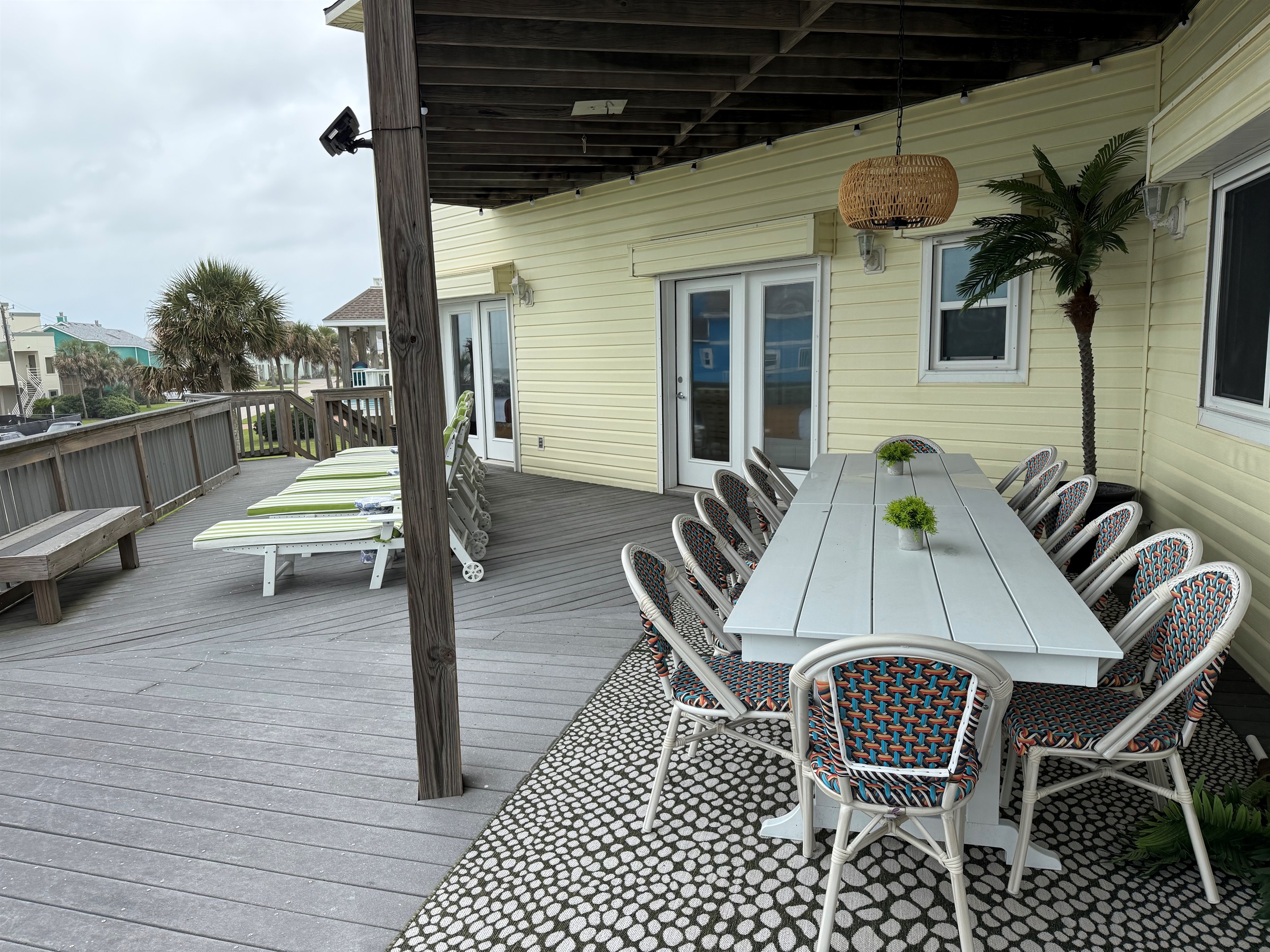 Main-Level Deck Outdoor Living
Dine alfresco with seating for 14 on the main-level deck, plus a cozy conversation area for 4 and 6 chaise lounges for soaking up the sun. Everything is set against sweeping Gulf-water views.