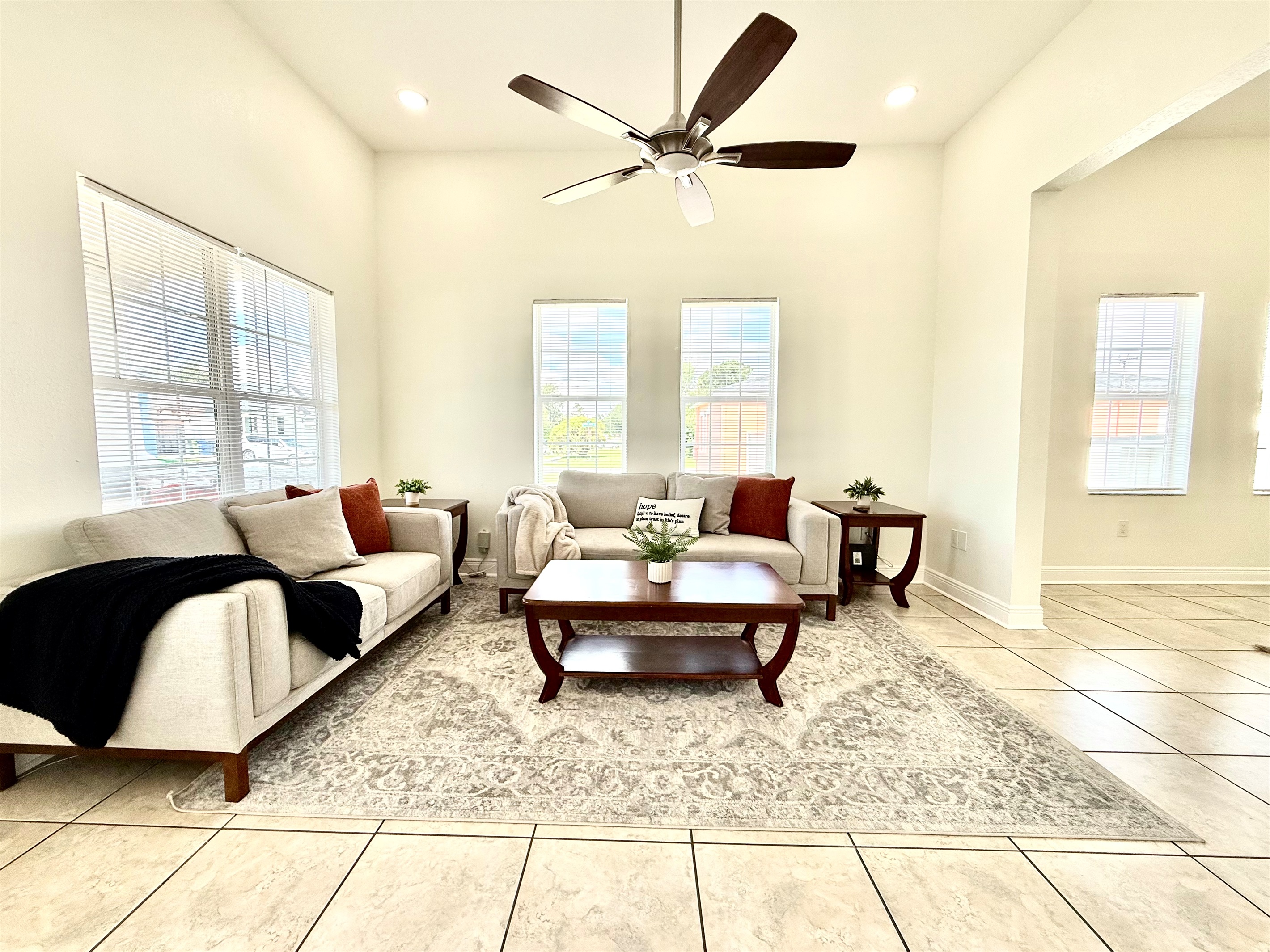 Vaulted ceilings and abundant windows elevate the space, while modern furniture adds function and flair.
