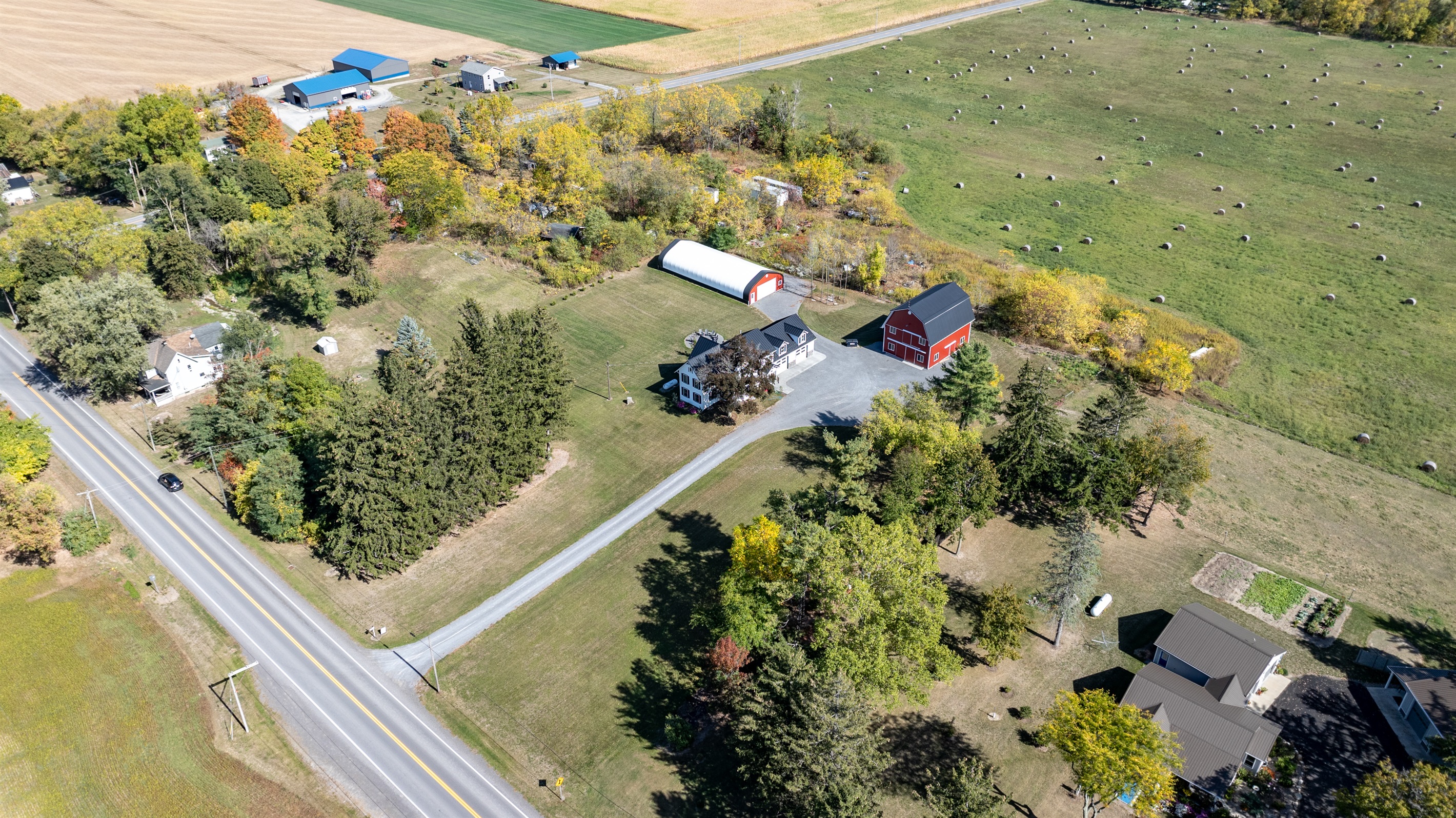 Wide aerial showing spacious layout, barns, and endless countryside views — a Finger Lakes gem
