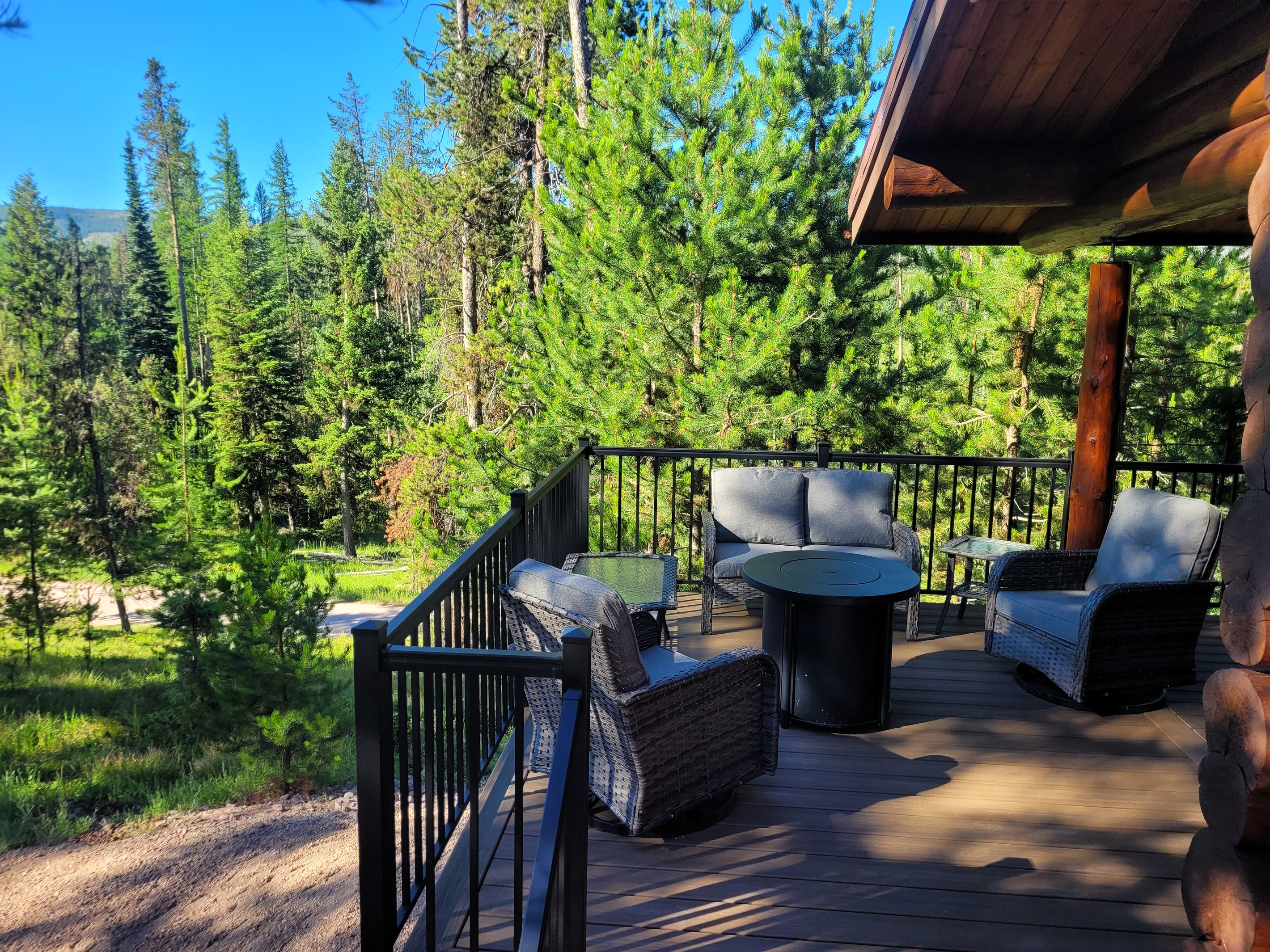 Enjoy dinner on a peaceful deck, centered around a propane firepit for cool evenings.