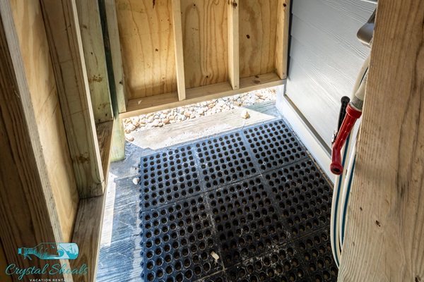 The private shower features hot/cold water, hose, and a changing area