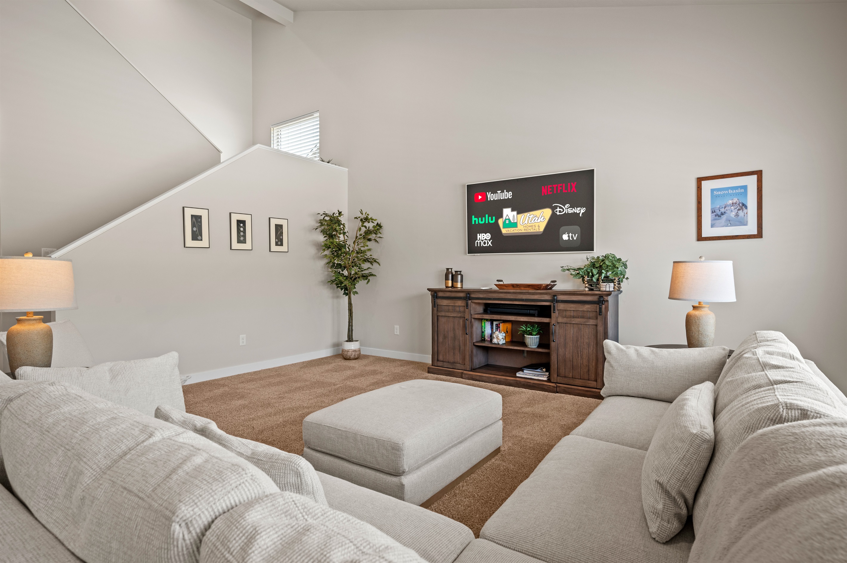 Bright and airy, this living room boasts high ceilings, cozy furnishings, and a welcoming atmosphere that makes you feel right at home.