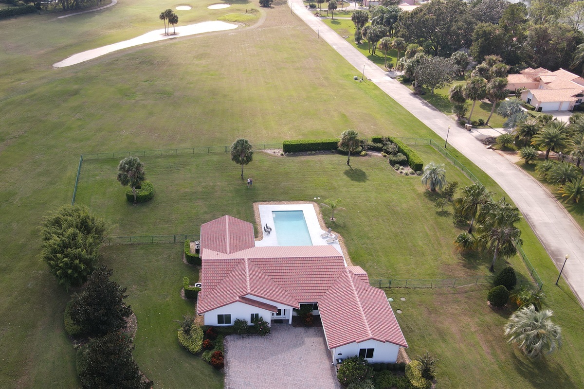 Drone view of property and golf course