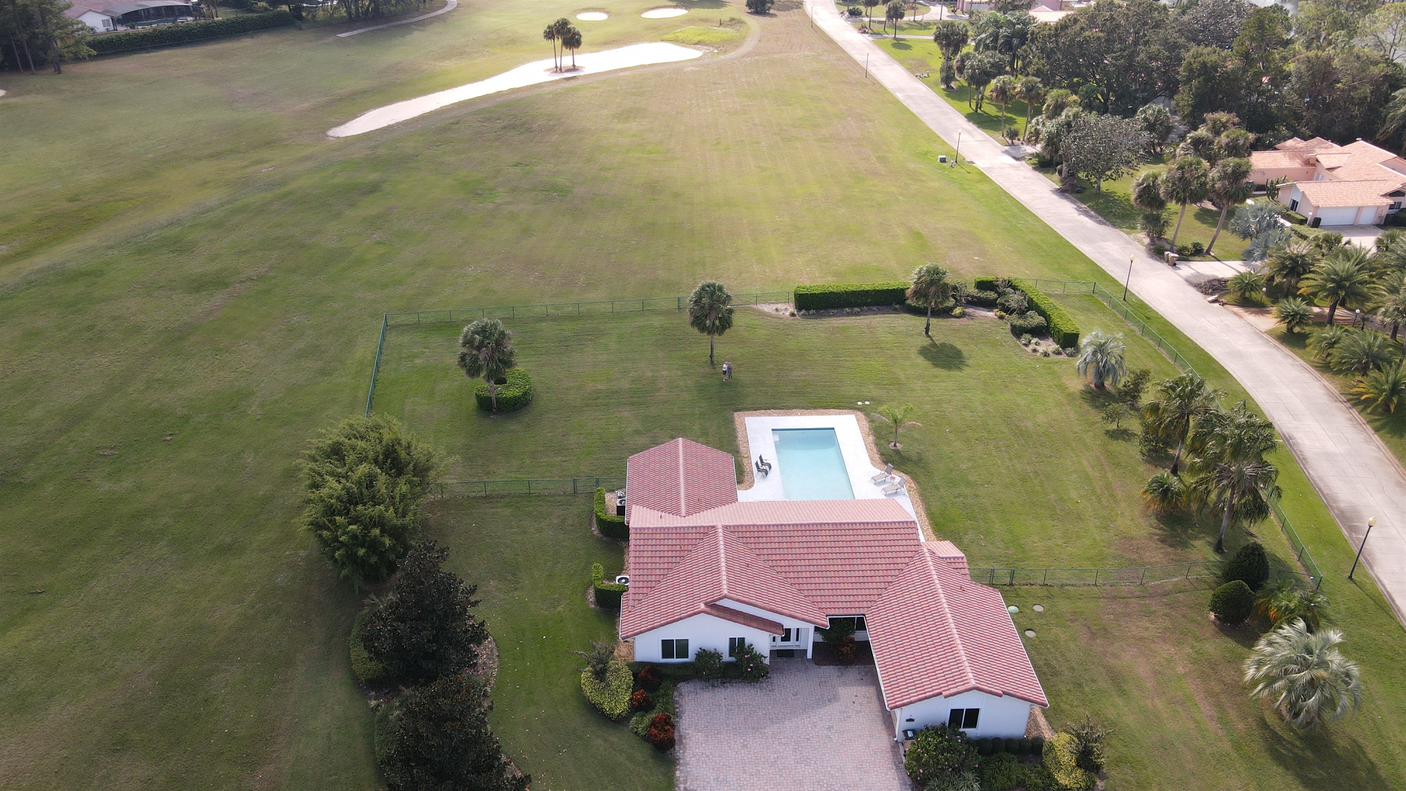 Drone view of property and golf course
