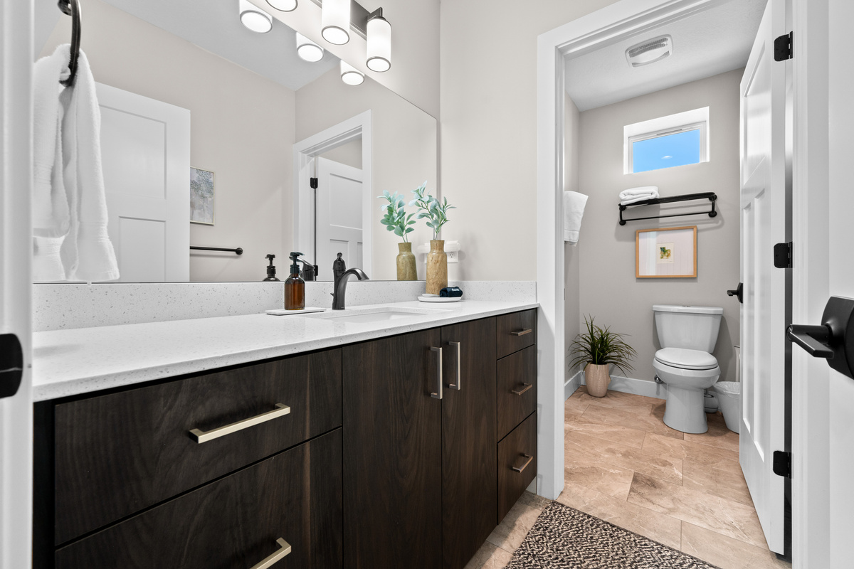 Spacious full bathroom with a modern vanity, generous counter space, and everything needed to prepare for the day.