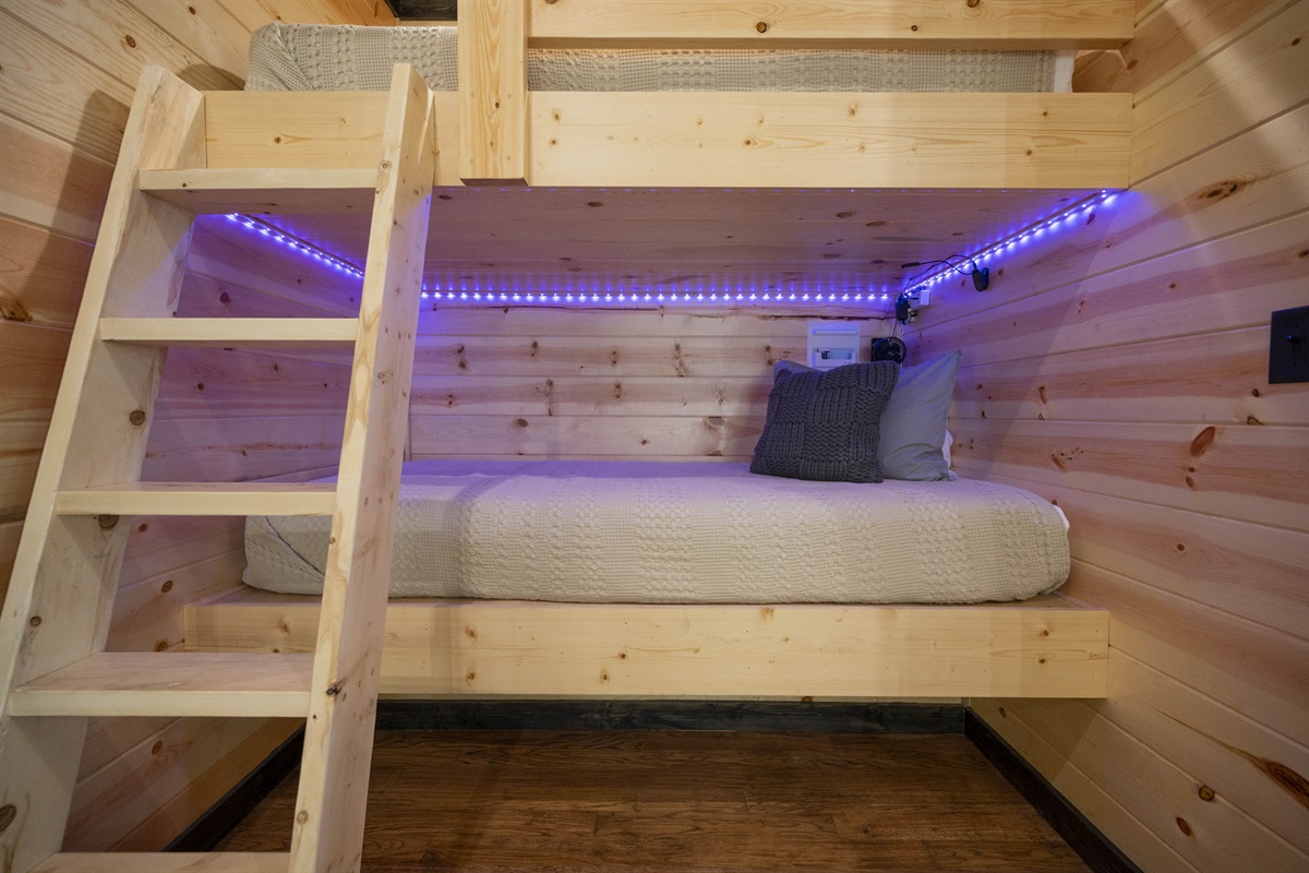 Bunk nooks each have fans and reading lamps. Storage under beds for luggage.