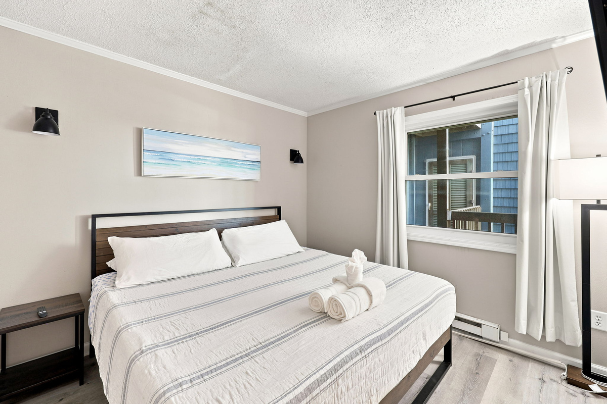 Relax and recharge in this comfortable bedroom featuring a cozy bed, coastal-inspired d&eacute;cor, and a peaceful atmosphere