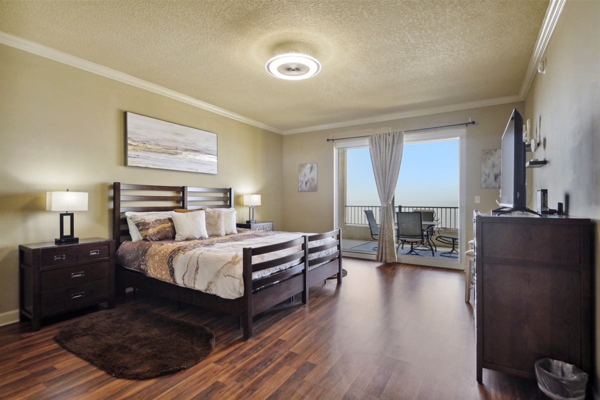 Main bedroom. King bed. Balcony access. Walk in closet. En-suite bathroom. Tv.