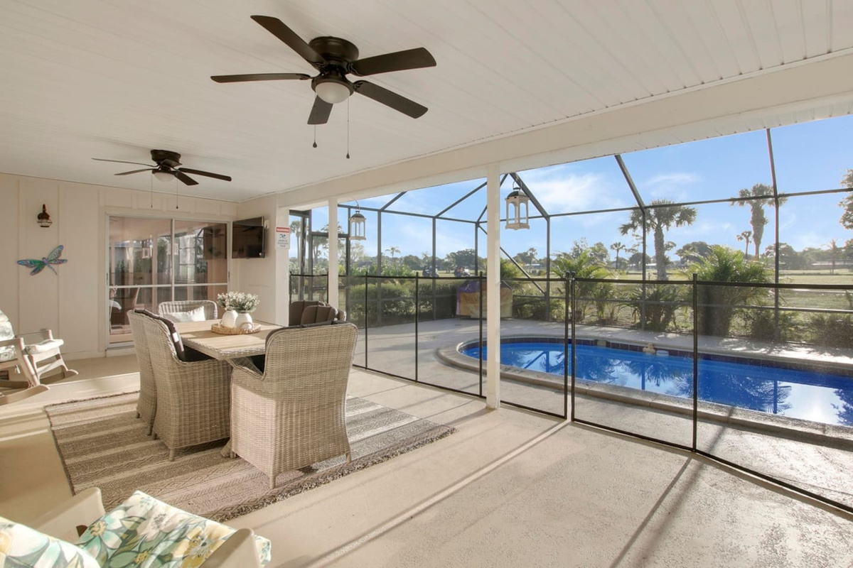 Beautiful screened in pool and patio area overlooking the golf course. The shaded seating area provides a cool way to be outside. There are also some sun lounge chairs available perfect for catching some sun during the day or star gazing at night.