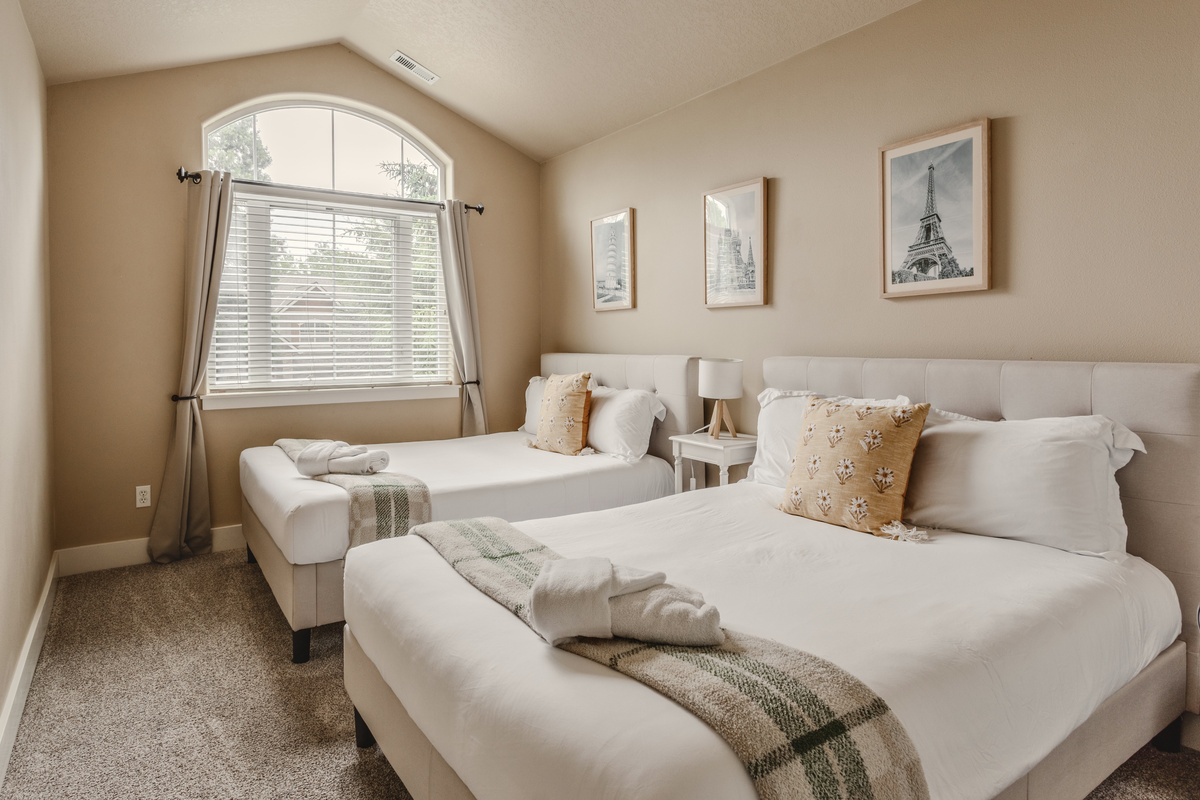 This bedroom features two full-size beds with medium-firm mattresses for restful sleep.