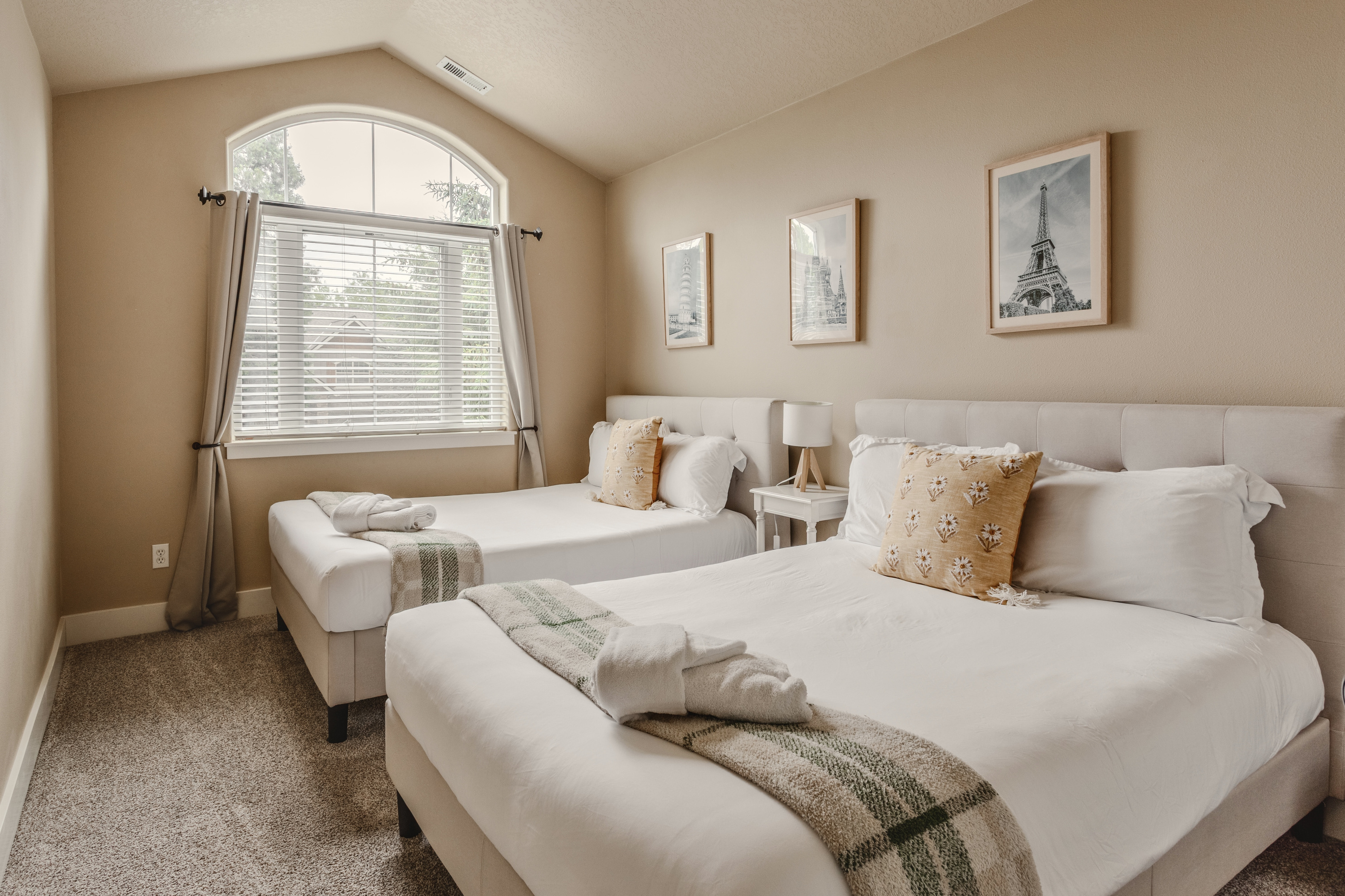 This bedroom features two full-size beds with medium-firm mattresses for restful sleep.