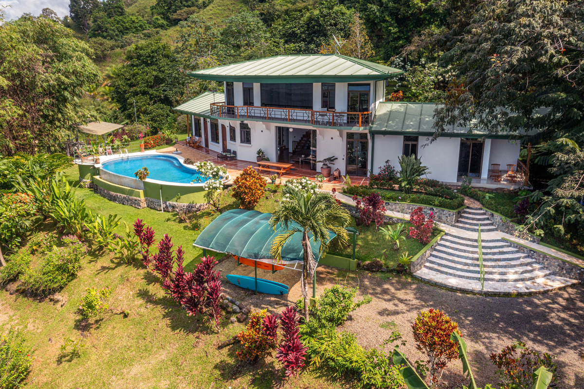 Aerial overview of Casa Infinity — hilltop estate, infinity pool, and two-plus acres of tropical grounds