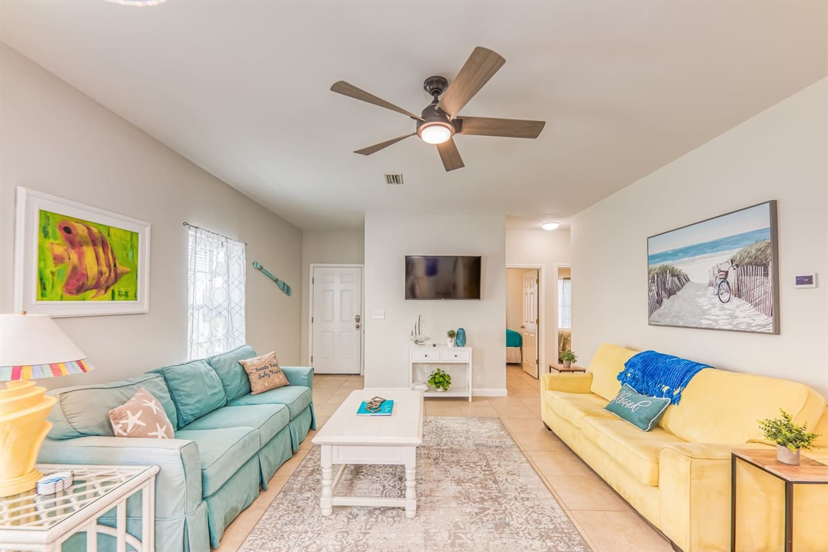Living Room: Bright and inviting space, perfect for relaxation with beachy decor and natural light!