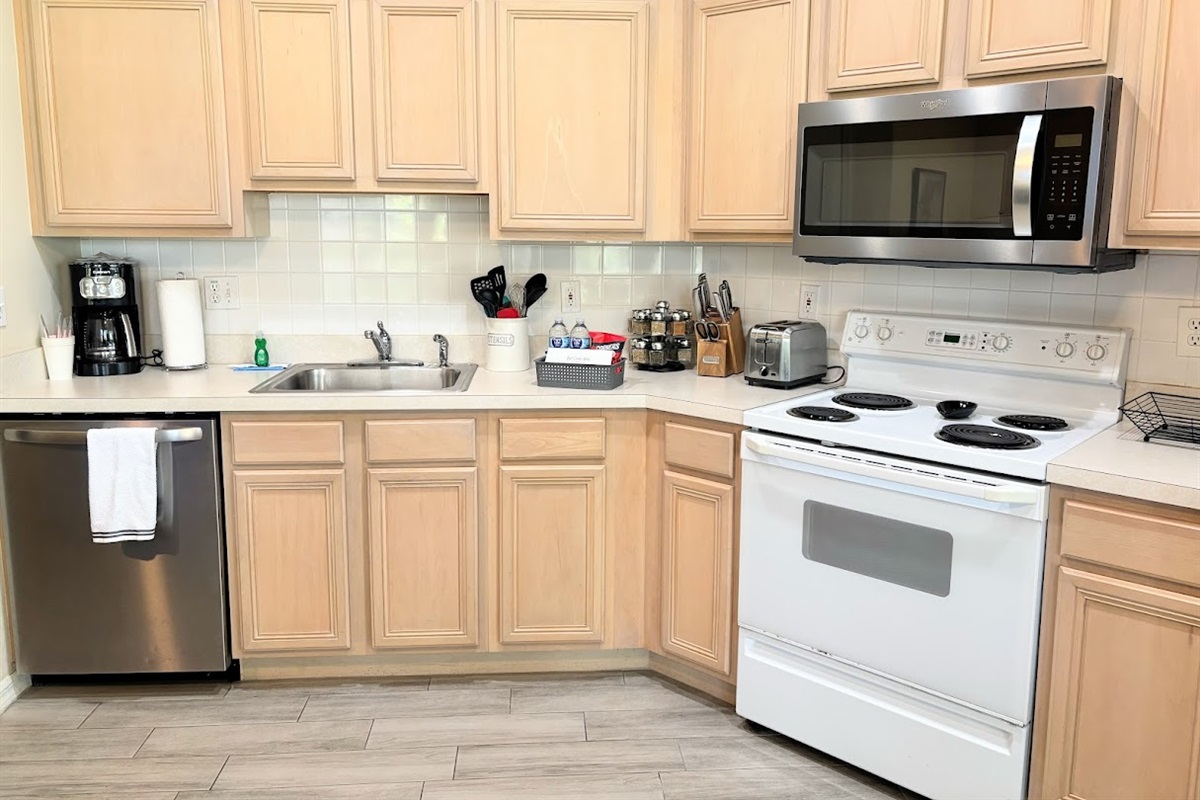 Functional kitchen with full-size appliances, ample cabinet storage, and a clean, convenient layout.