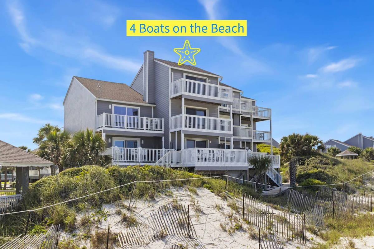 Take in the full height of 4 Boats on the Beach from the Gulf side &mdash; three decks stacked above the sand.