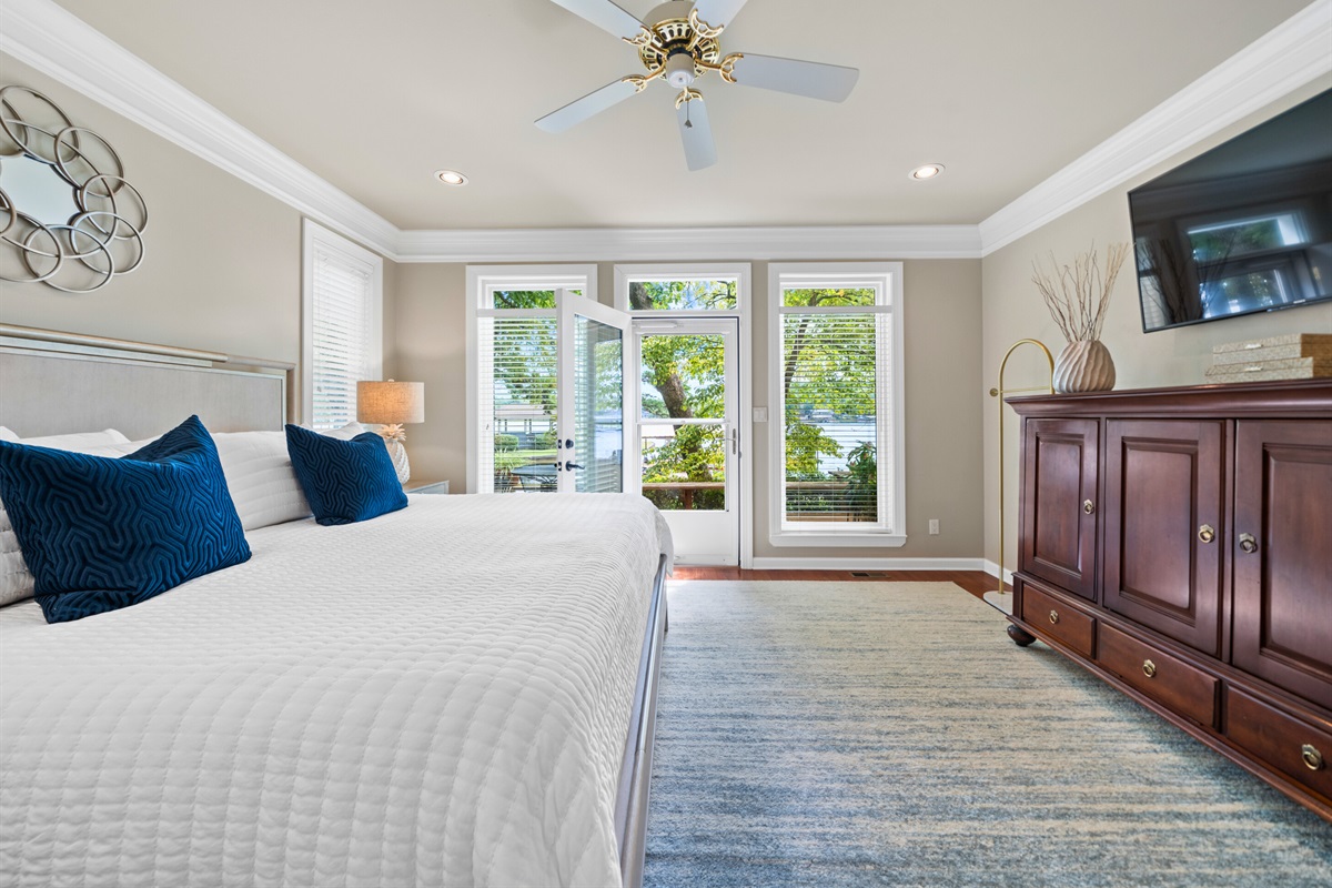 A peaceful king suite with bright windows and elegant furnishings &mdash; wake up to the lake.