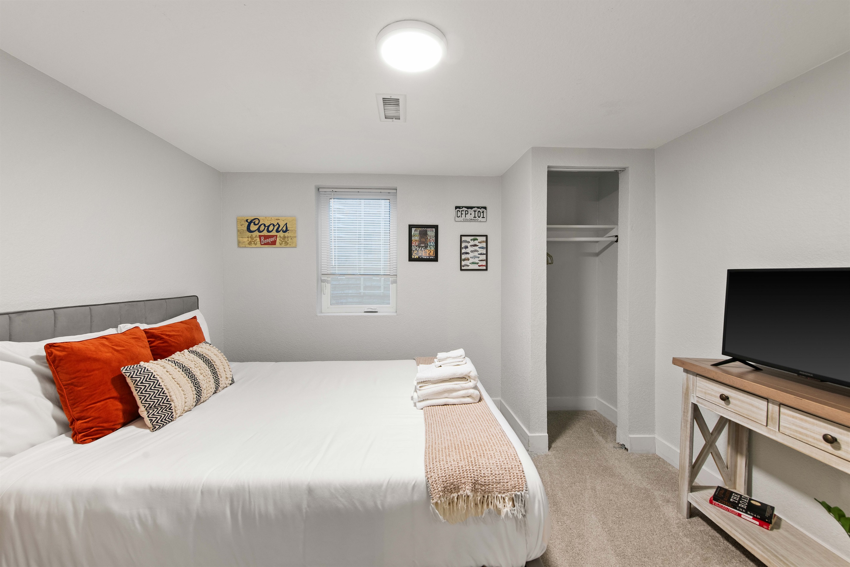 Lower level bedroom with smart TV and plenty of natural light