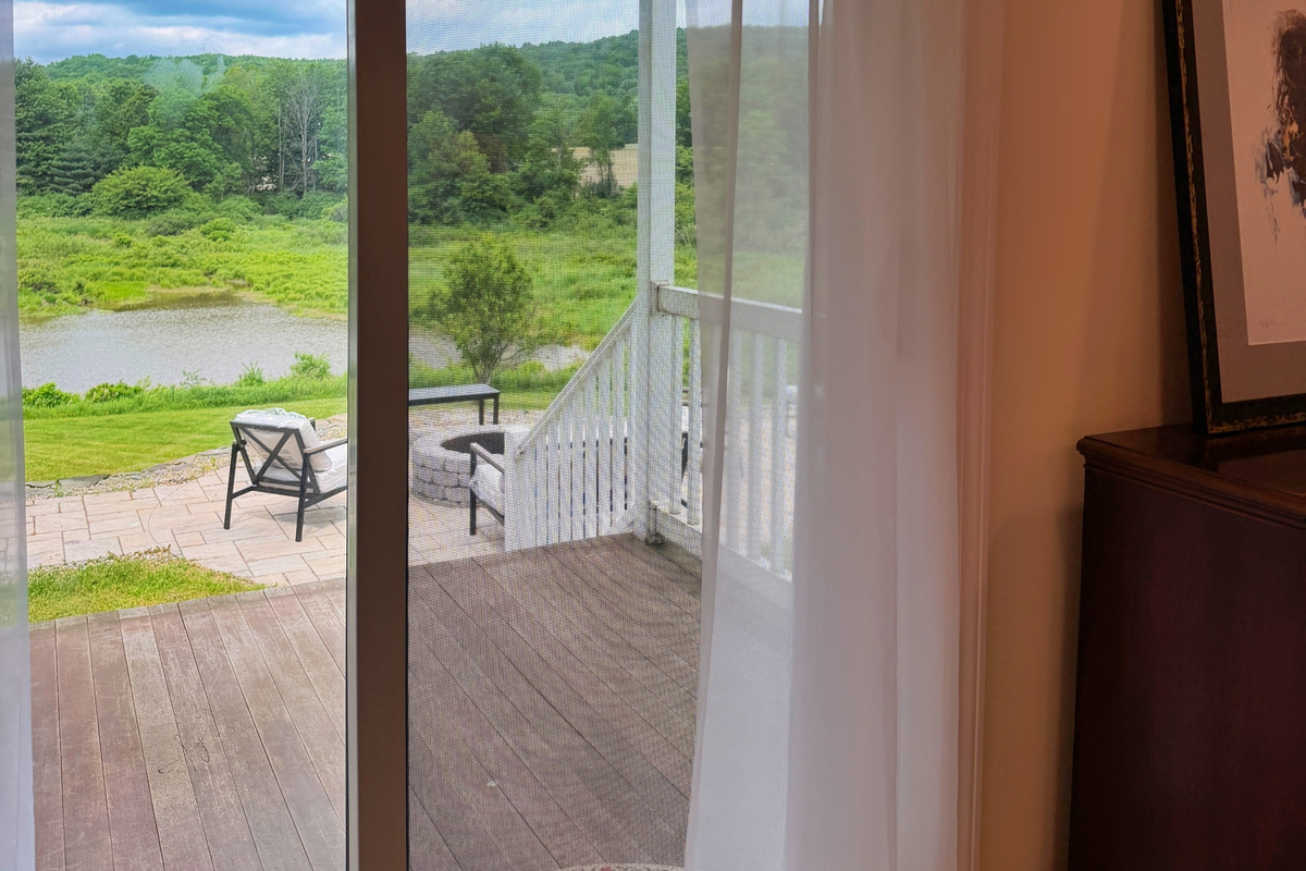 Lower level King Bedroom with sliding glass doors to a private sitting porch