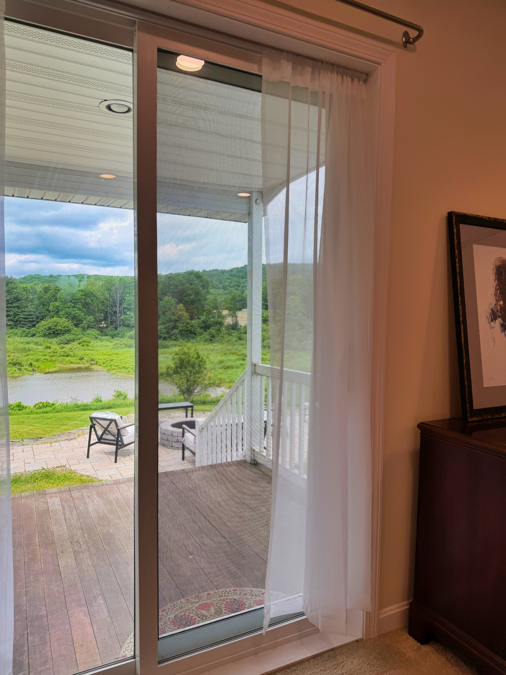 Lower level King Bedroom with sliding glass doors to a private sitting porch