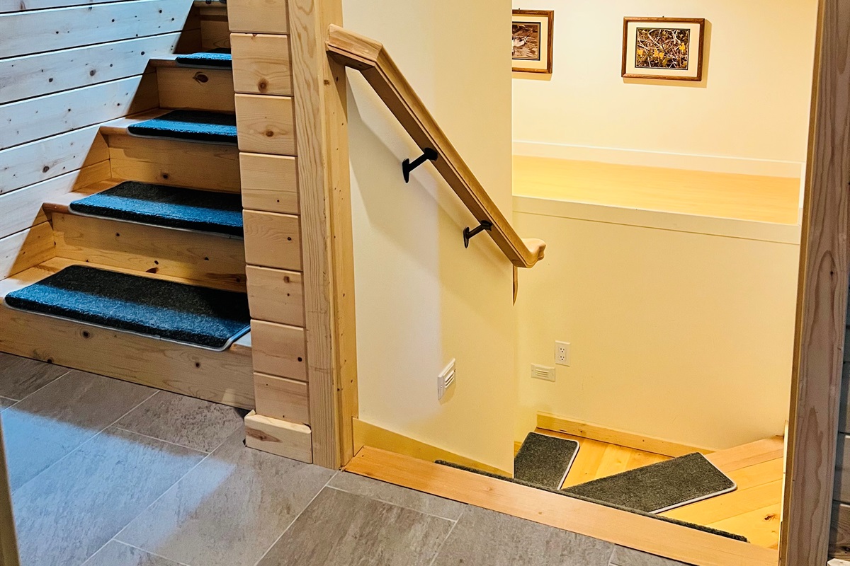 This home has three levels allowing guests to have their own private areas of the home. Stairs on primary level lead both upstairs and downstairs to lower basement level.