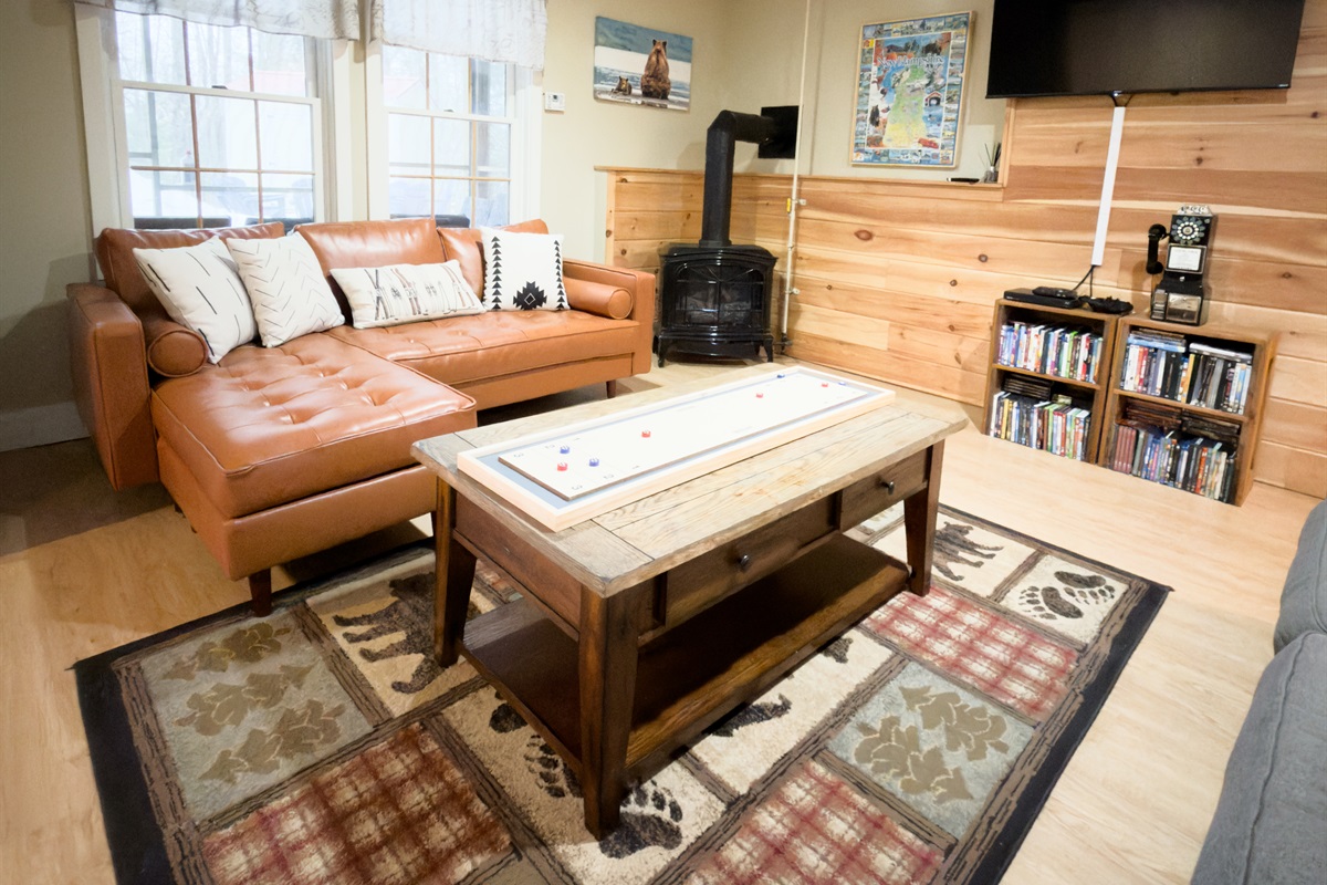 Living Room - Lower Level. Ultimate hangout spot, warm up by the gas fireplace, sink into the couch or game night. 