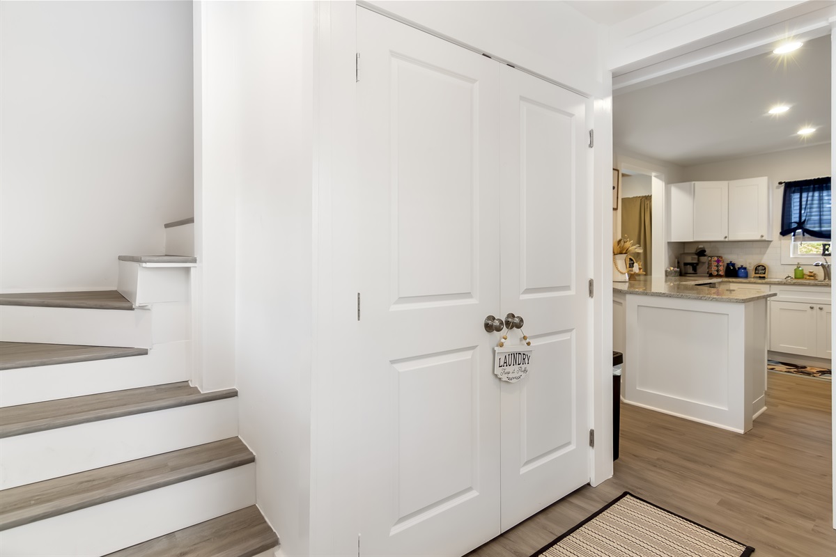 Laundry closet and stairs leading to the upstairs level