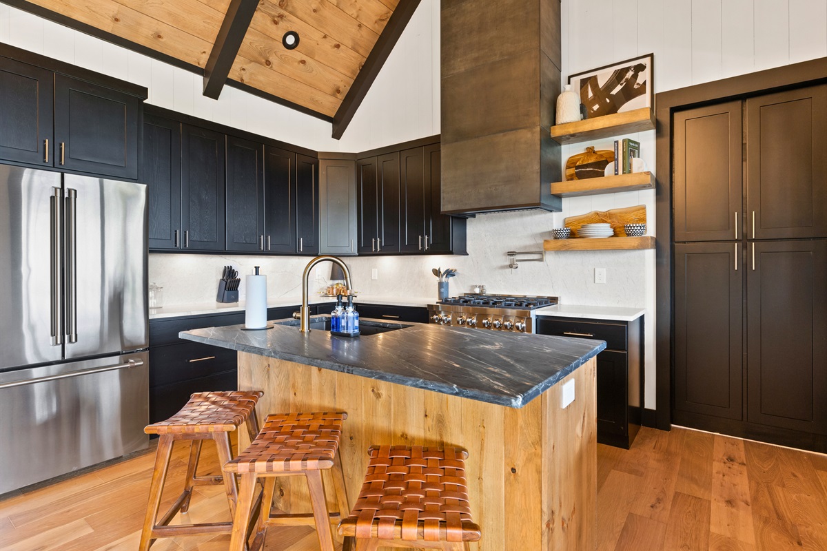 Experience culinary delight in the modern kitchen, where sleek appliances meet warm wood accents, all designed to inspire your inner chef.