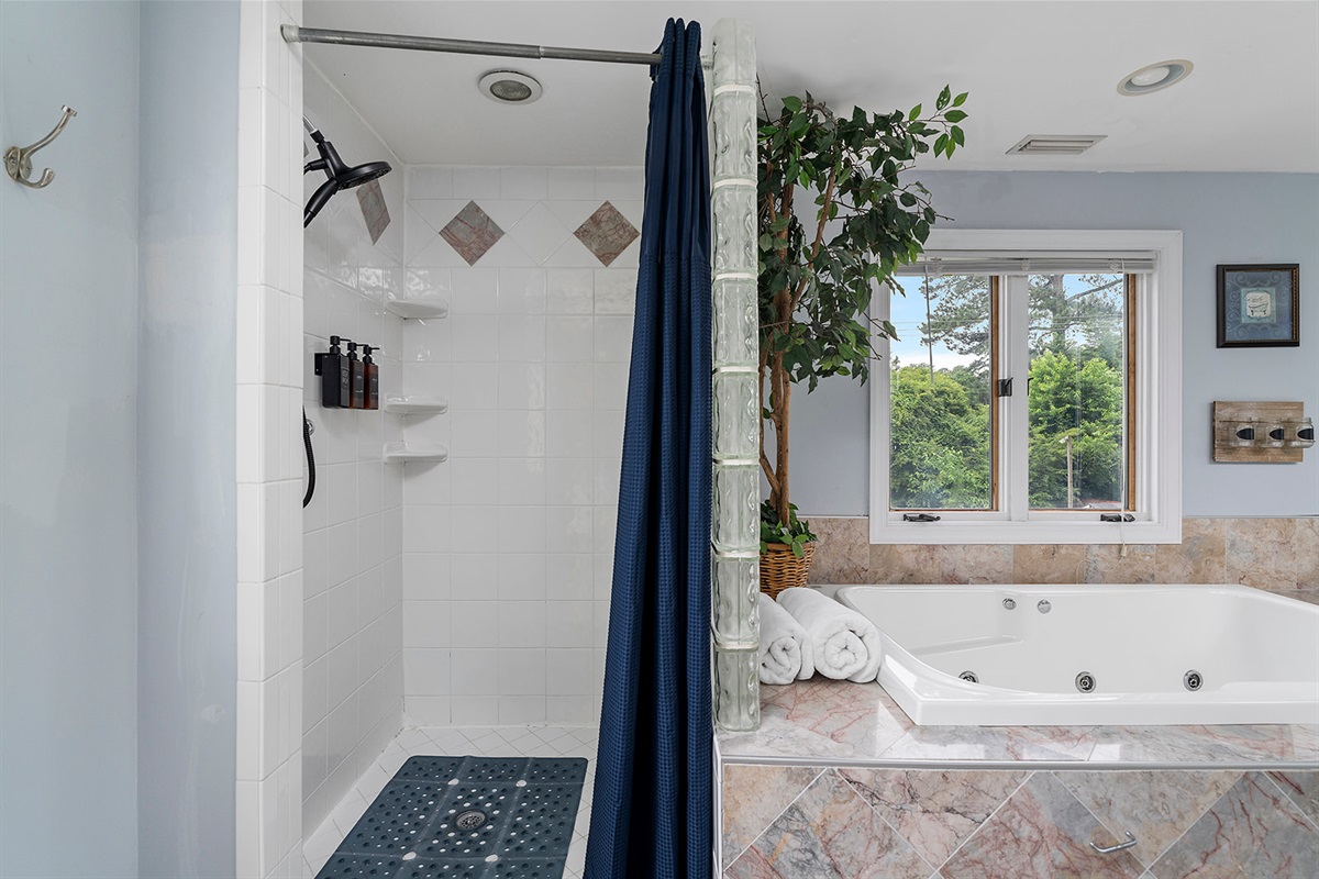 Master Bathroom 1: Indulge in relaxation with a luxurious soaking tub and scenic views!
