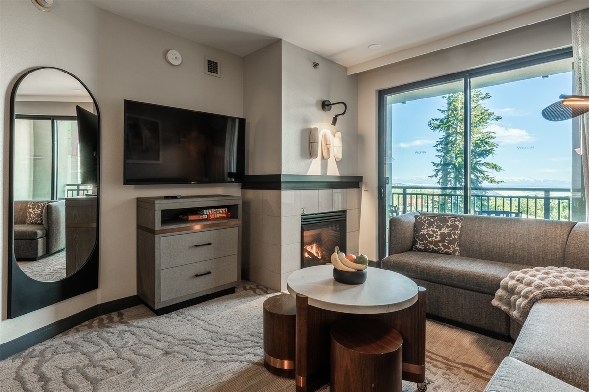 With light spilling into Point Sierra from the large window and the fireplace at its heart, the living space feels bright, calm, and effortlessly inviting.