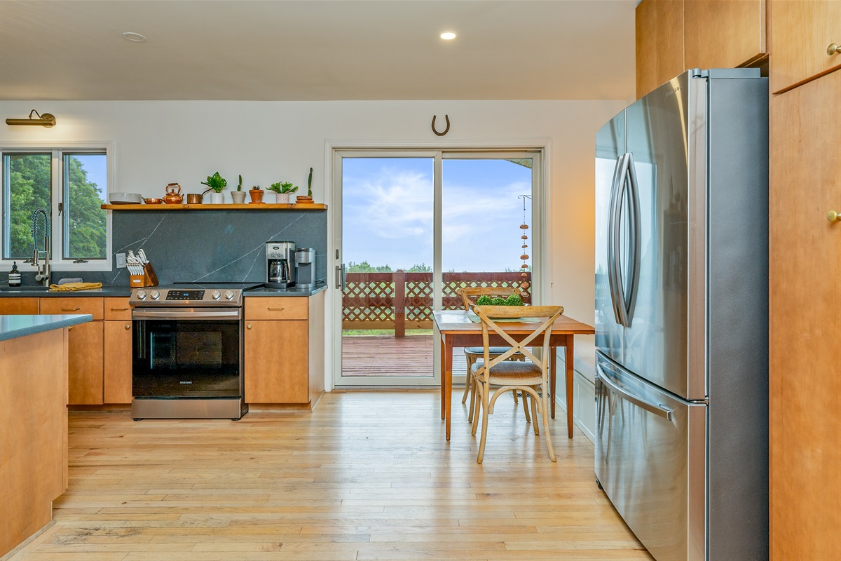 Start your mornings right with coffee and sunshine at this adorable breakfast nook overlooking the deck and garden.